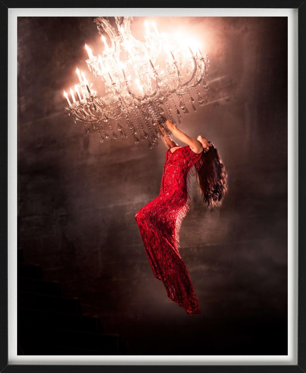 Hanging on, Woman in a red dress, Fine Art Photography, 2020 - Beige Color Photograph by David Drebin