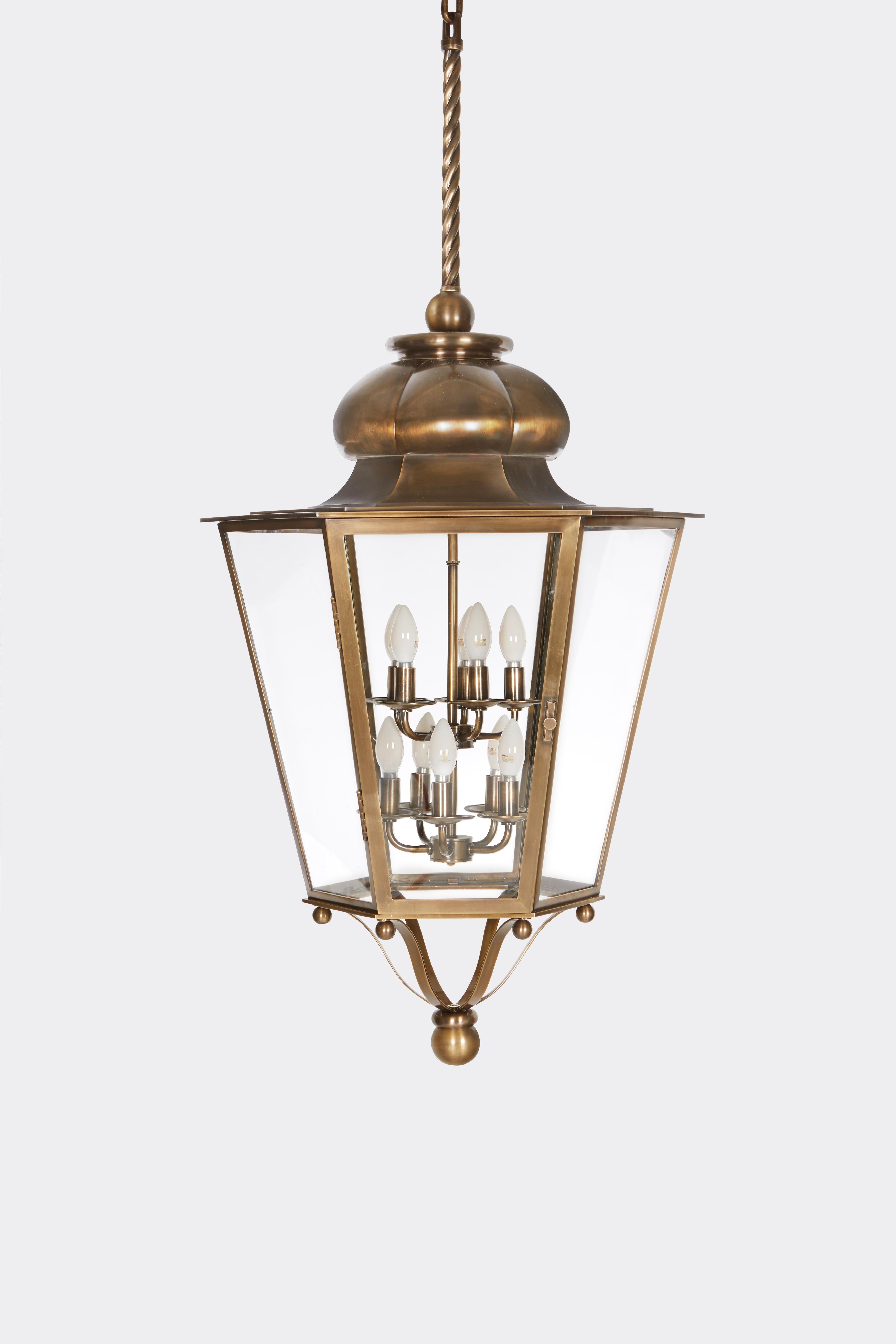 A Brass Georgian Styled Lantern made by David Duncan Studio. This fixture is suspended from a chain and canopy with an intricate rope-like design. Consists of 10 sockets with a maximum wattage of 100W each. 

This fixture is available in custom