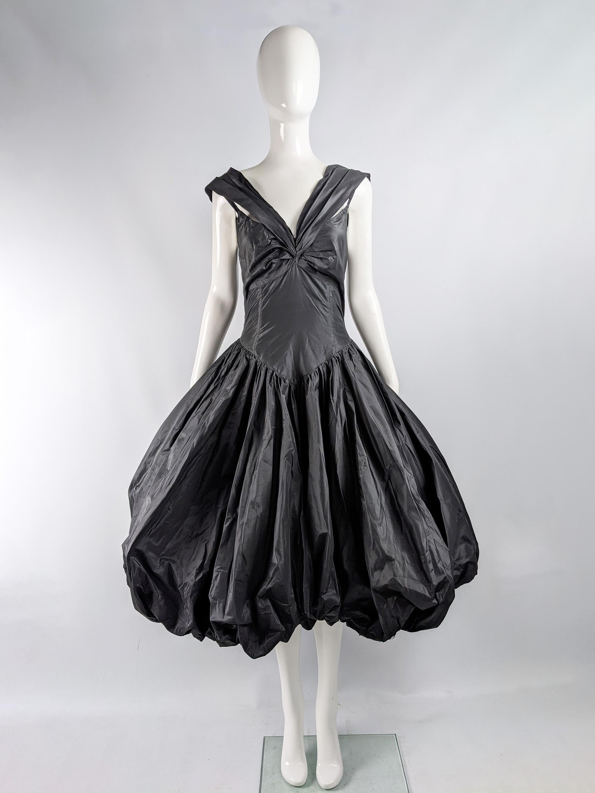 An absolutely breathtaking vintage womens dress from the 80s by luxury British fashion designer, David Fielden. Incredible quality,  in a black silk taffeta with a huge puffball skirt and double strap detail. Perfect for a formal party or red carpet