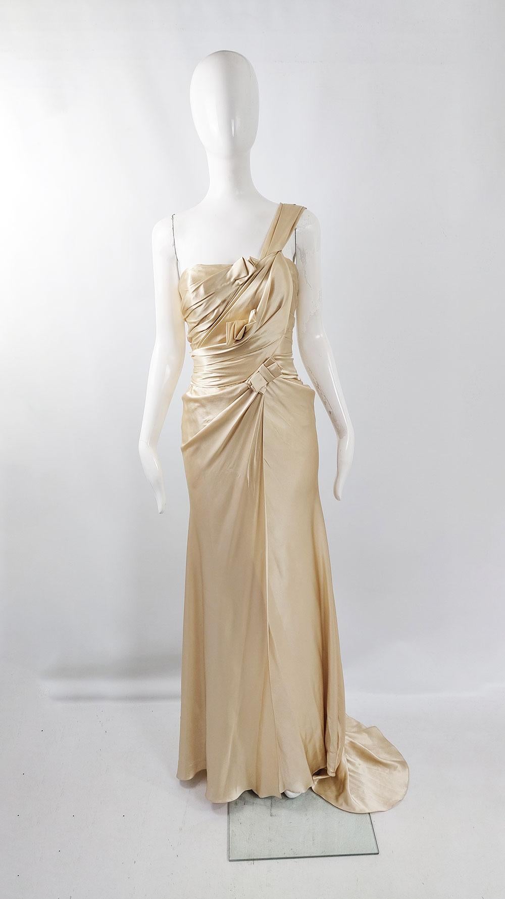 An exquisite vintage women's one-shoulder formal evening / wedding gown from luxury British designer David Fielden's bridal line 'Sposa'. The gown is crafted from pale gold silk charmeuse satin and features stunning Grecian goddess-style pleating at