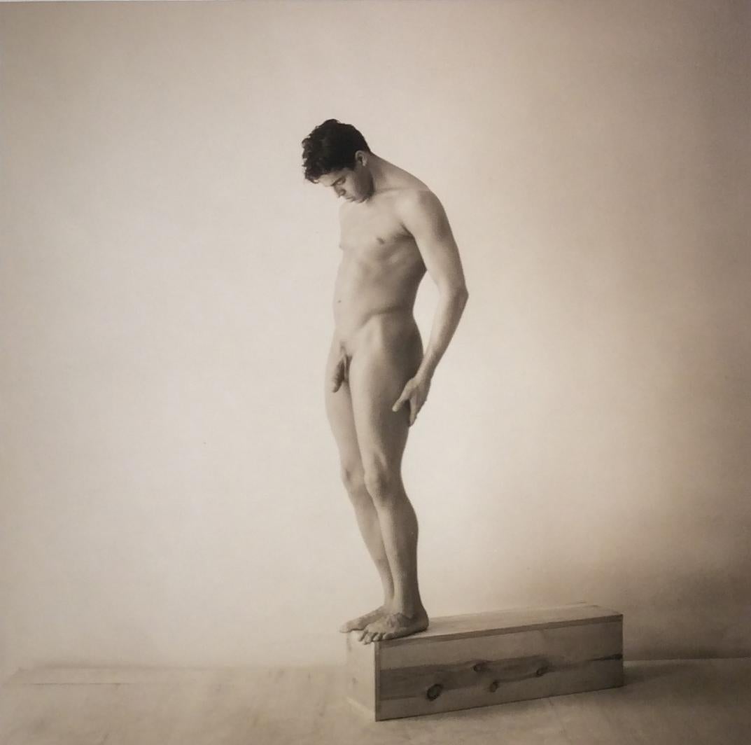 David Halliday Figurative Photograph - Male Nude, Standing: Sepia Toned Portrait Photograph in Wood Frame