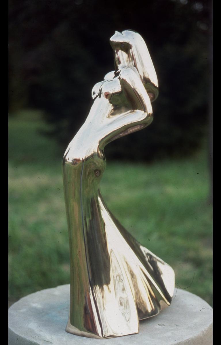 Dancing Lady in polished bronze is sealed with Glasurit- it never needs to be polished. She is cast from a wood carving of Dancing Lady- an iconic Hostetler form. The dynamic head lift, the dramatic sweep of the skirt and turn of the hip all combine