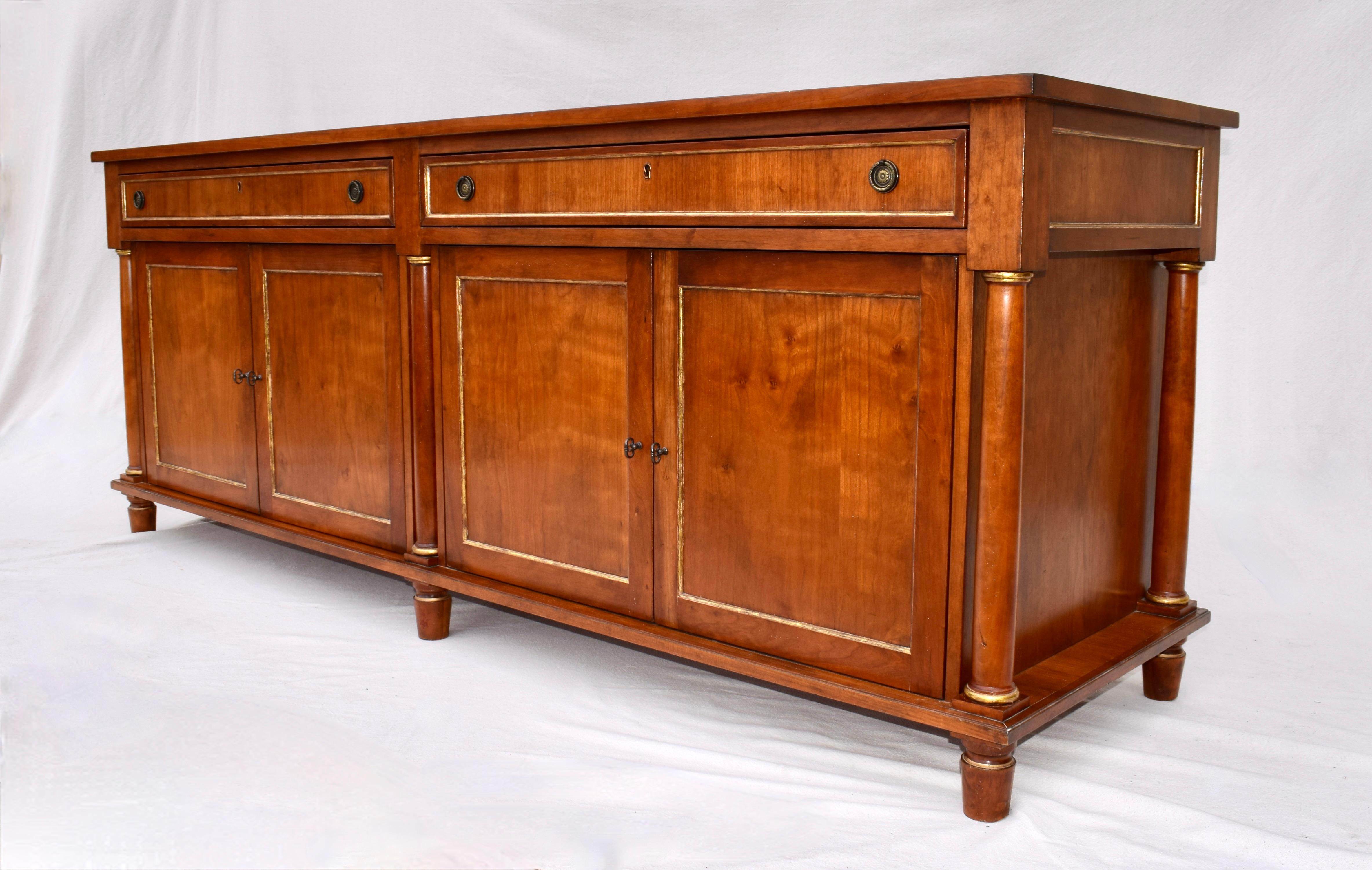 David Iatesta custom sideboard cabinet server with two drawers, generous cabinetry beneath with pullout adjustable shelving & six columnade supports. In the Neoclassical style, the sideboard is of solid Cherry featuring gilt trim throughout.