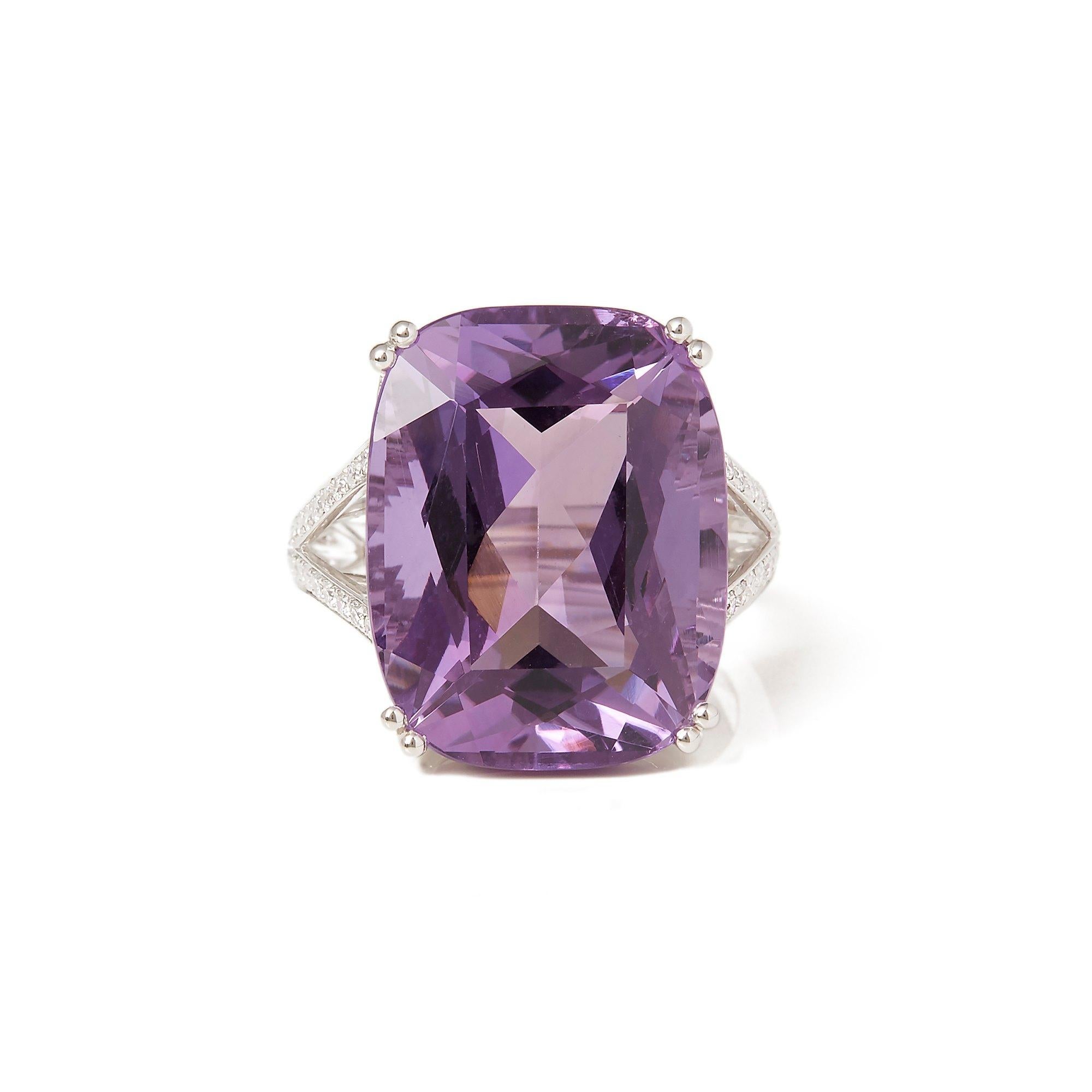 This ring designed by David Jerome is from his private collection and features one cushion cut Amethyst totalling 17.23cts sourced in Russia. Set with round brilliant cut Diamonds totalling 0.40cts mounted in an 18k white gold setting. UK finger