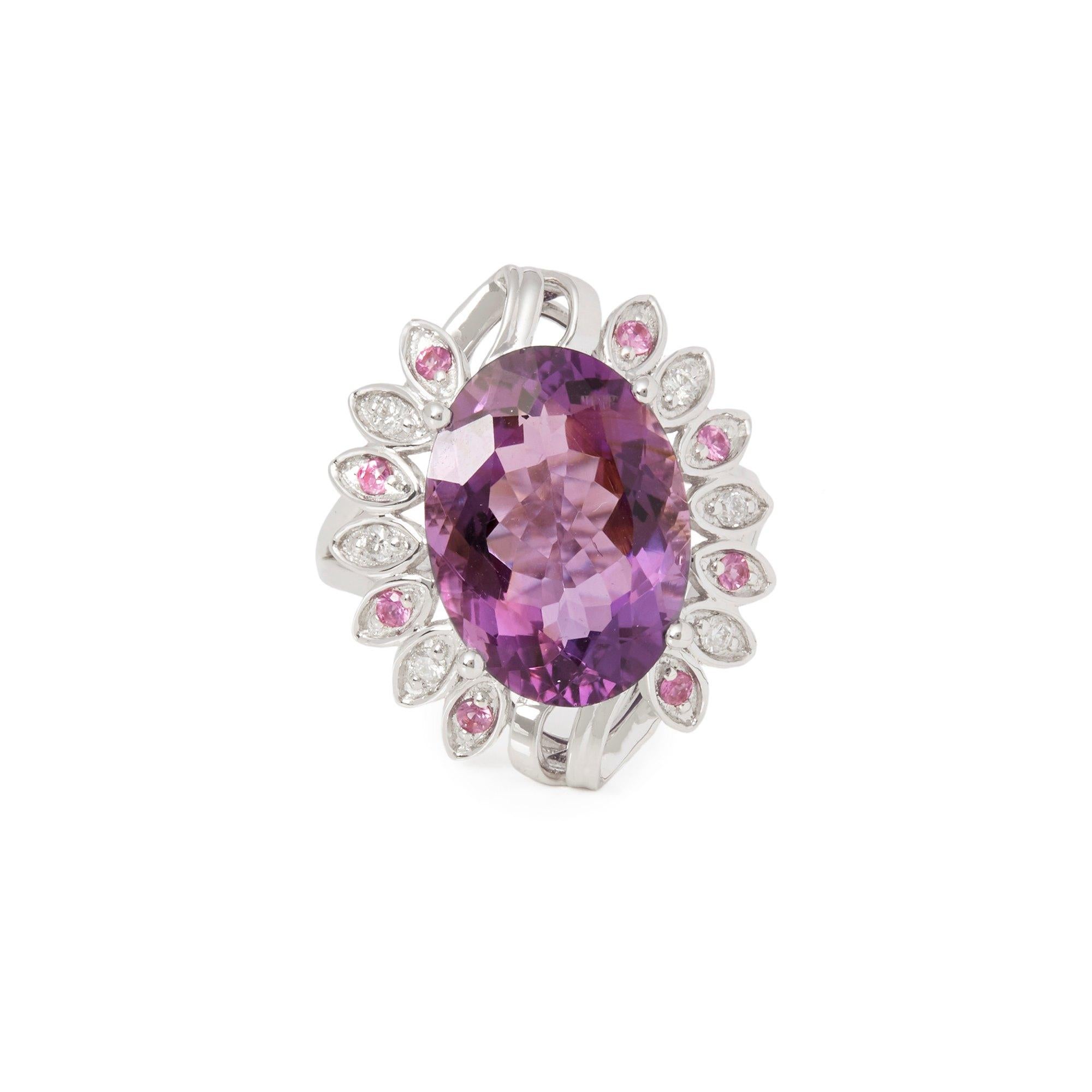 This ring designed by David Jerome is from his private collection and features one oval cut Amethyst totalling 7.07cts sourced in Russia. Set with round brilliant cut Diamonds and pink Sapphires mounted in an 18k white gold setting. UK finger size M
