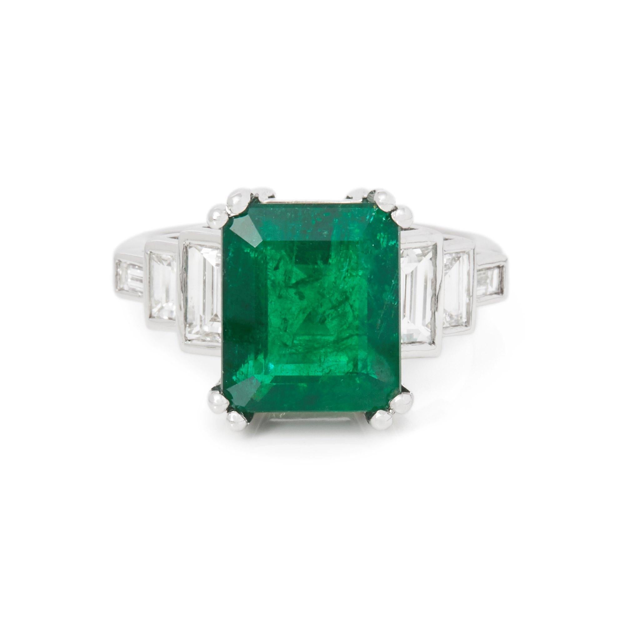 This ring designed by David Jerome is from his private collection and features one square Emerald cut Emerald totalling 4.80cts sourced in Columbia. Set with step baguette cut Diamonds totalling 1.12cts mounted in an 18k white gold setting. UK