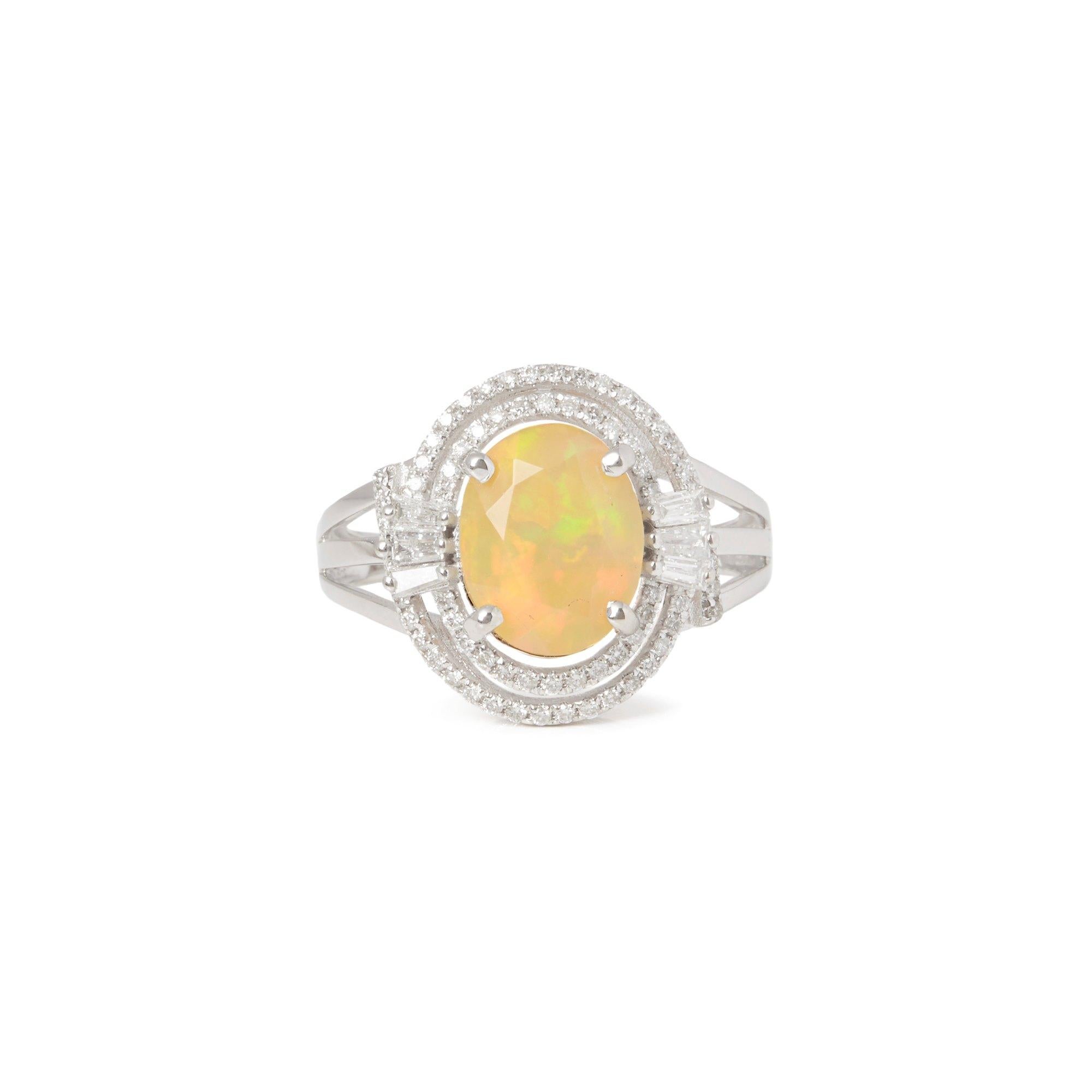 This Ring Designed by David Jerome is from his Private Collection and features One Oval Cut Opal Totalling 1.89cts Sourced in Ethiopia. Set with Round Brilliant Cut Diamonds Totalling 0.49cts Mounted in an 18k White Gold Setting. Finger Size UK N