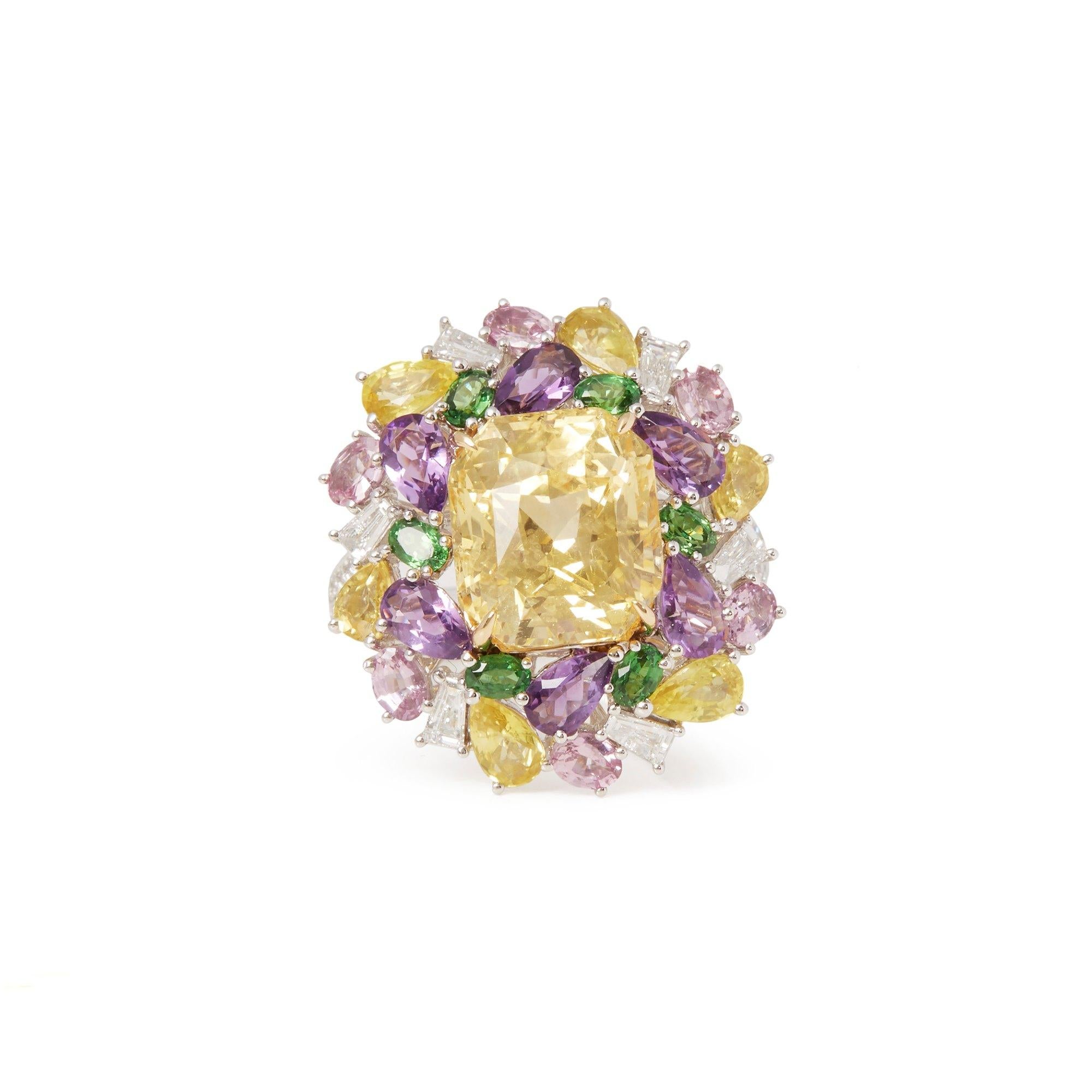 This ring designed by David Jerome is from his private collection and features one cushion cut yellow Sapphire totalling 8.26cts sourced in Sri Lanka. Set with mixed fancy colour Sapphires and round Brilliant cut Diamonds totalling 0.50cts mounted
