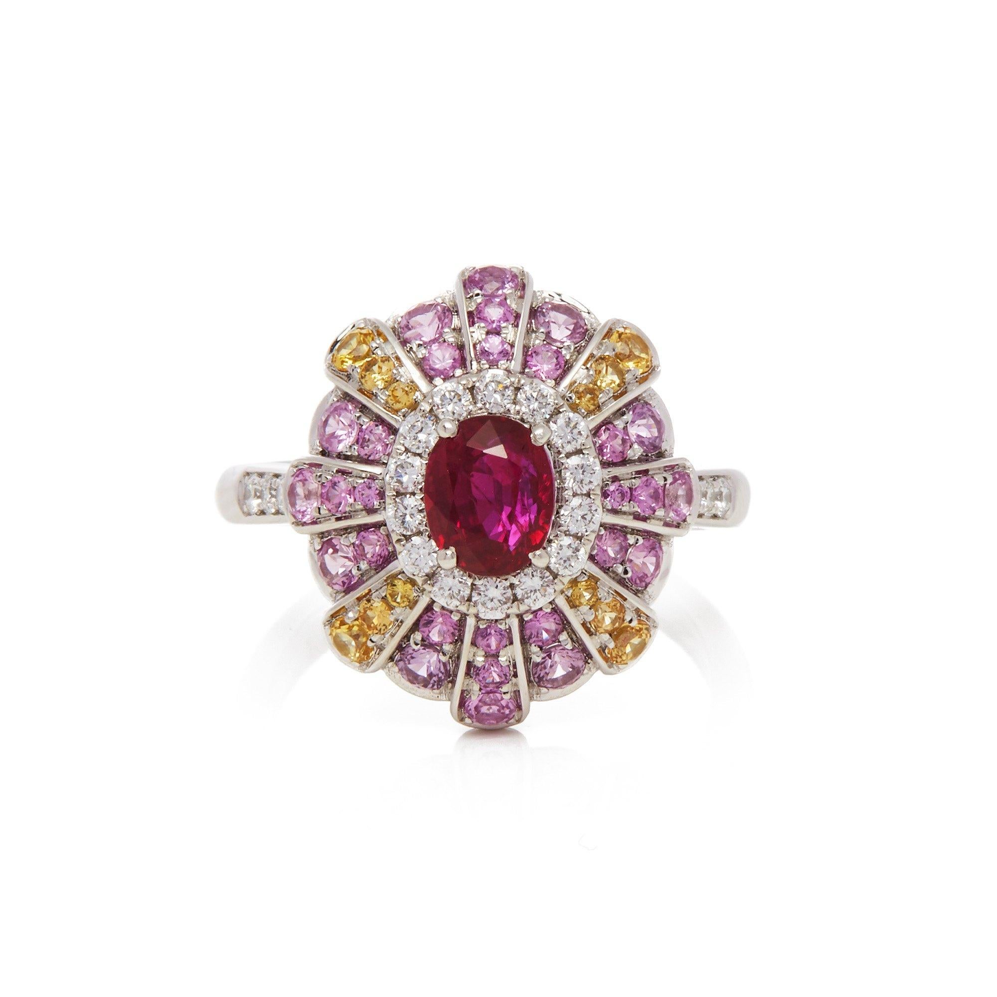 This ring designed by David Jerome is from his private collection and features one oval cut Ruby sourced in Mozambique. Set with a mix of round brilliant cut Diamonds, pink and yellow Sapphires totalling 1.71cts combined. Mounted in platinum. Ring
