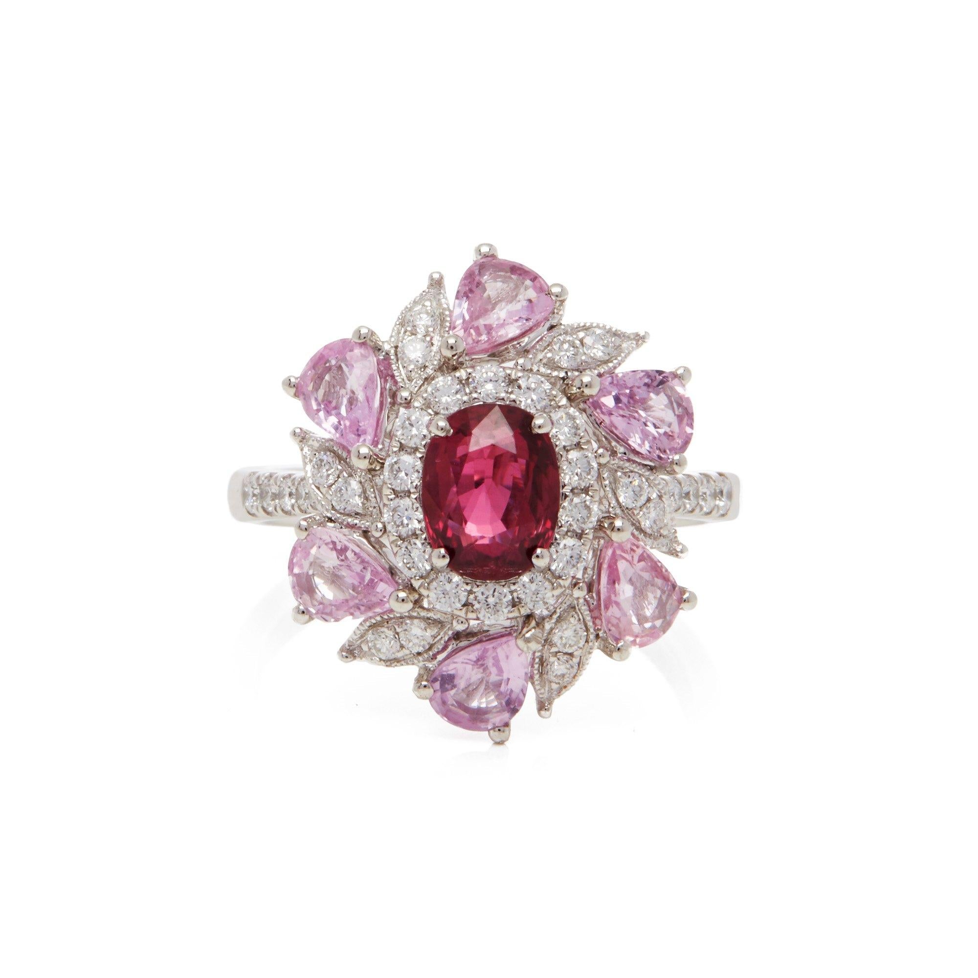 This Ring Designed by David Jerome is from his Private Collection and features One Oval Cut Ruby Sourced in Mozambique. Set with a mix of Round Brilliant Cut Diamonds and Pear Cut Pink Sapphires Totalling 2.28cts combined. Mounted in Platinum. Ring