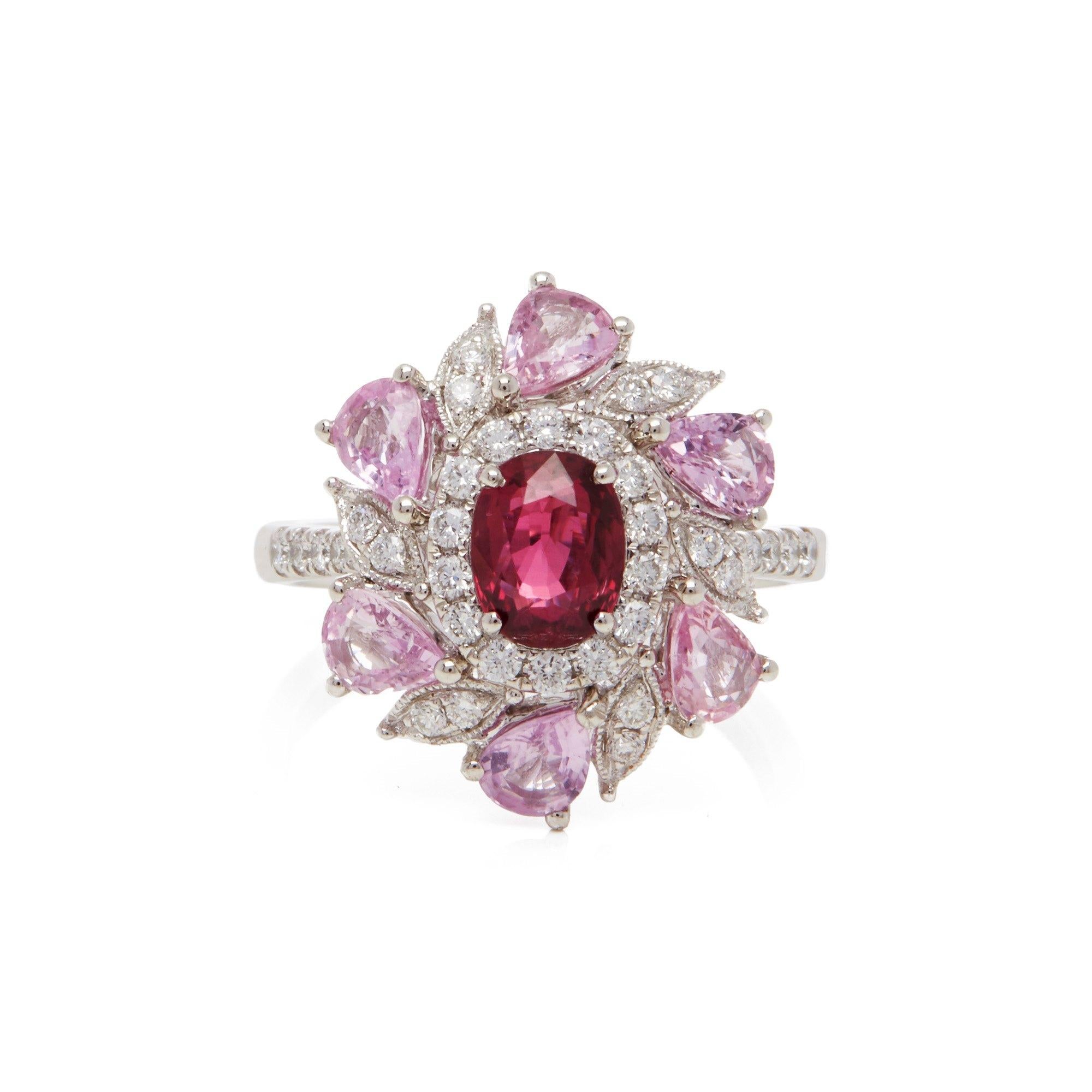 This ring designed by David Jerome is from his private collection and features one oval cut Ruby sourced in Mozambique. Set with a mix of round brilliant cut Diamonds and pear cut pink Sapphires totalling 2.28cts combined. Mounted in platinum. Ring