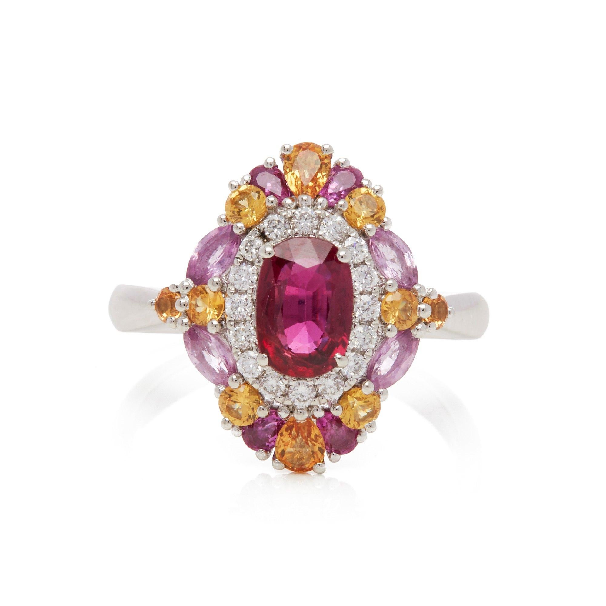 This ring designed by David Jerome is from his private collection and features one oval cut Ruby sourced in Mozambique. Set with a mix of round brilliant cut Diamonds, pink and yellow Sapphires totalling 1.70cts combined. Mounted in platinum. Ring