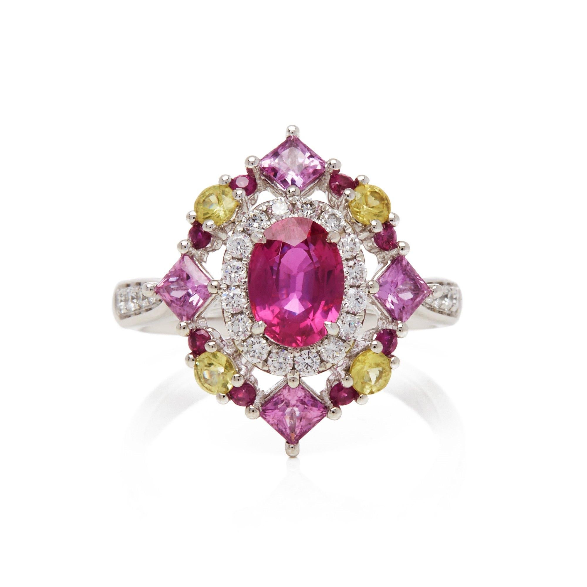 This ring designed by David Jerome is from his private collection and features one oval cut Ruby sourced in Mozambique totalling 1.30cts. Set with a mix of round brilliant cut Diamonds, pink and yellow Sapphires totalling 1.73cts combined. Mounted