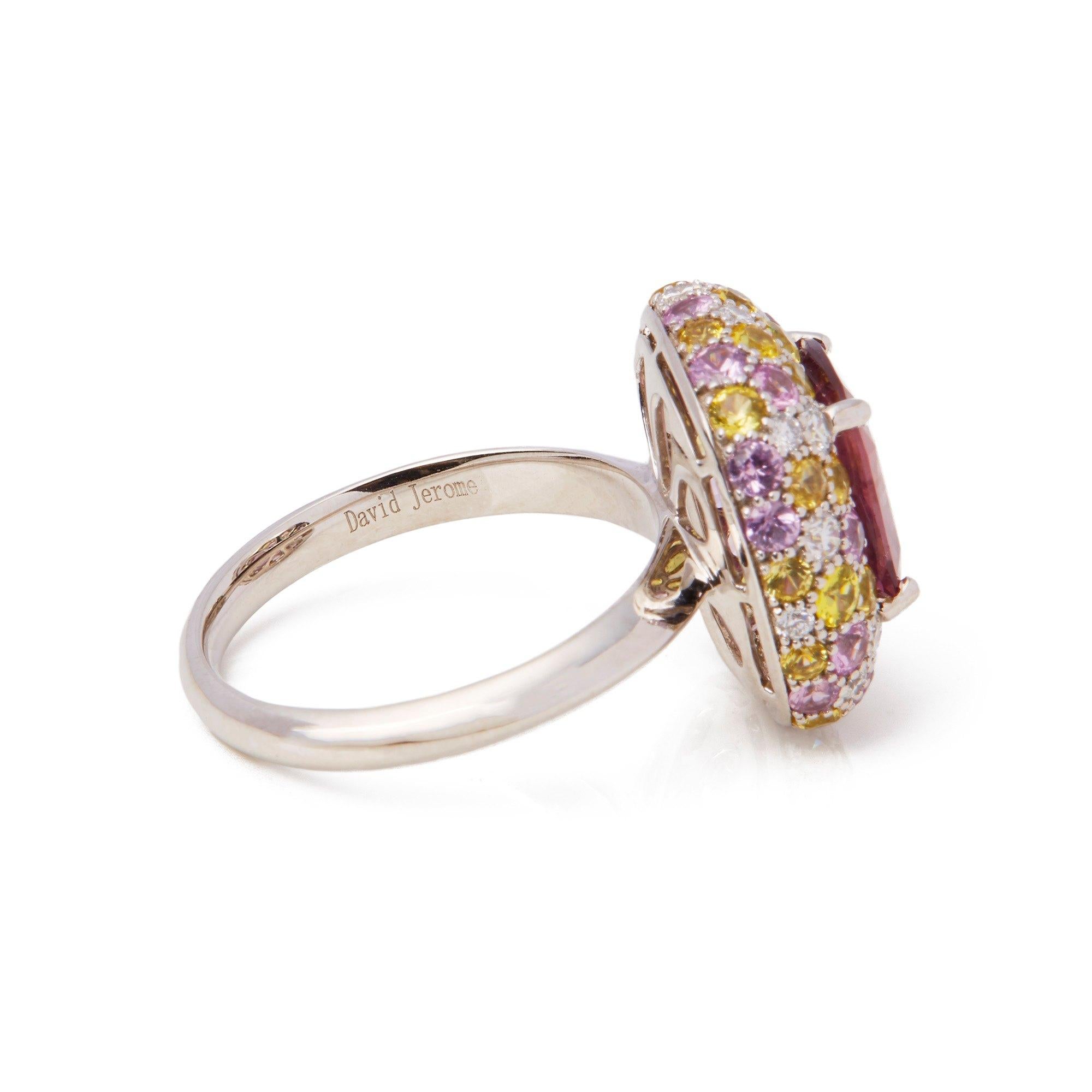 This ring designed by David Jerome is from his private collection and features one untreated cushion cut padparadscha Sapphire sourced in Sri Lanka. Totalling 3.10cts set with round brilliant cut Diamonds, pink and yellow Sapphires. Mounted in