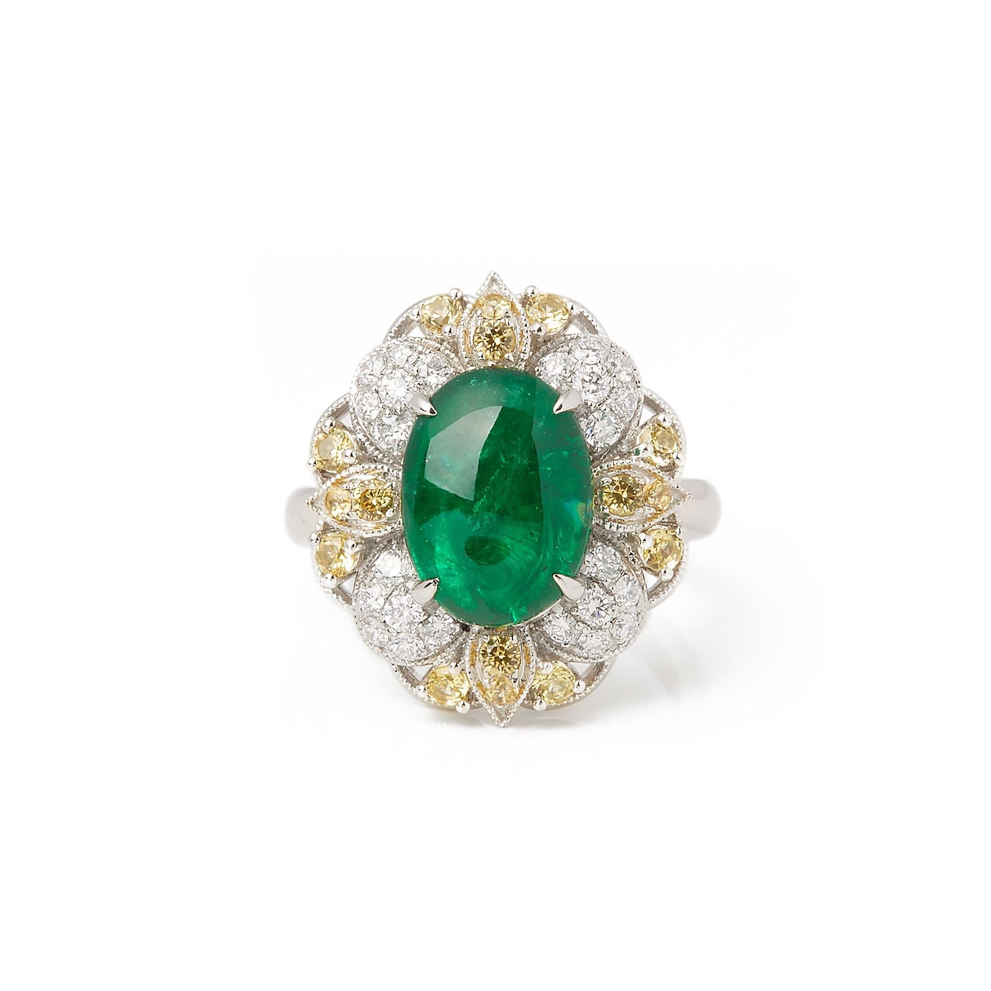 This ring designed by David Jerome is from his private collection and features one cabochon cut Emerald sourced in the chivor Mine in Columbia. Totalling 6.41cts set with round brilliant cut Diamonds and yellow Sapphires totalling 0.51cts. Mounted