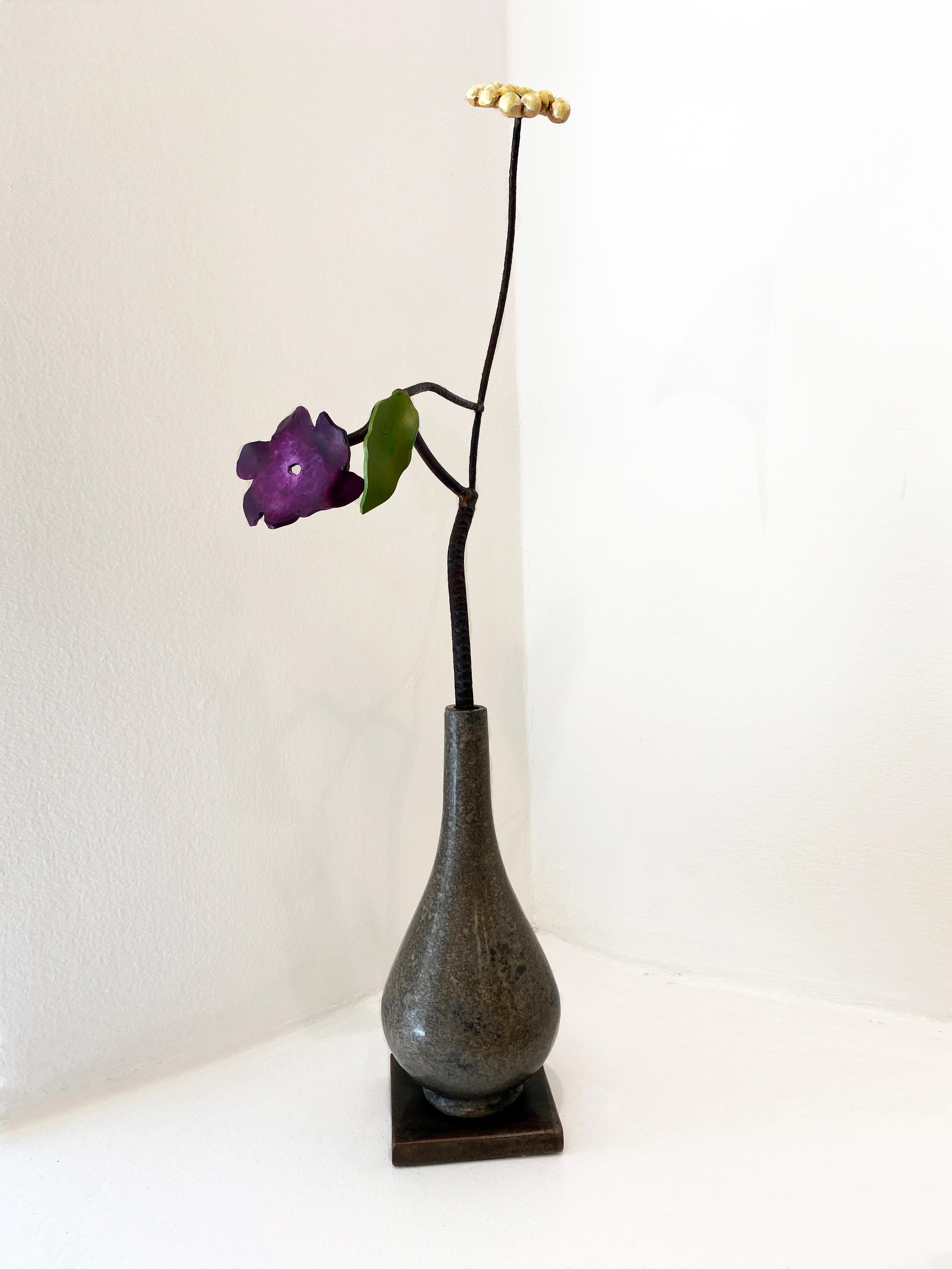 Available at Madelyn Jordon Fine Art. 'Silver Water Bottle with Flower and Yarrow' by David Kimball Anderson, 2023. Bronze, steel, and paint, 27 x 8 x 8 in. This sculpture features a rounded vase cast in bronze and finished with a gray patina. It