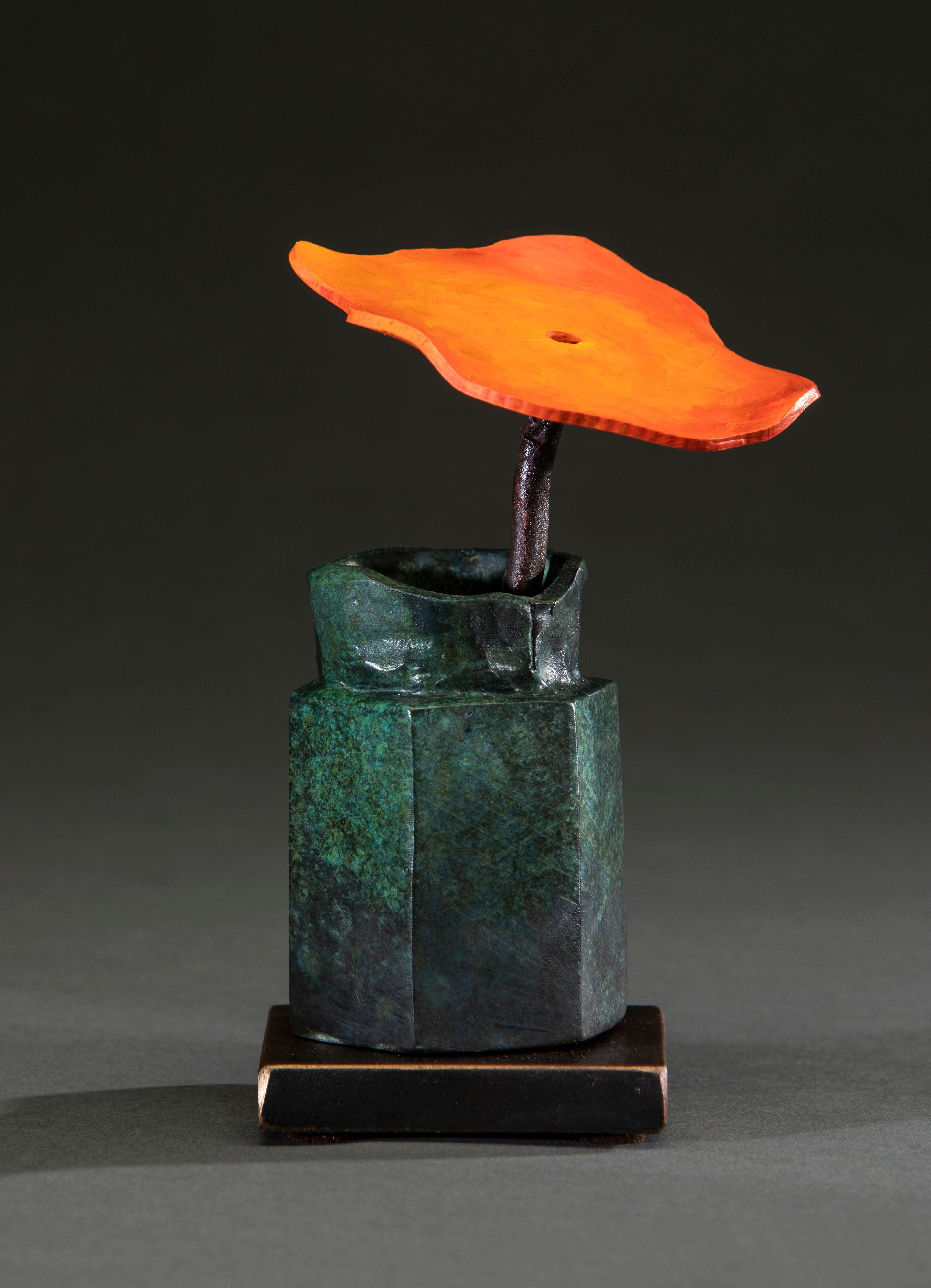 'Japanese Bottle Orange Flower' by David Kimball Anderson, 2022. Bronze, steel, and paint, 6 x 6 x 6 in. This sculpture features a cylindrical vase cast in bronze and finished with a green patina. It features one large steel flower, painted bright