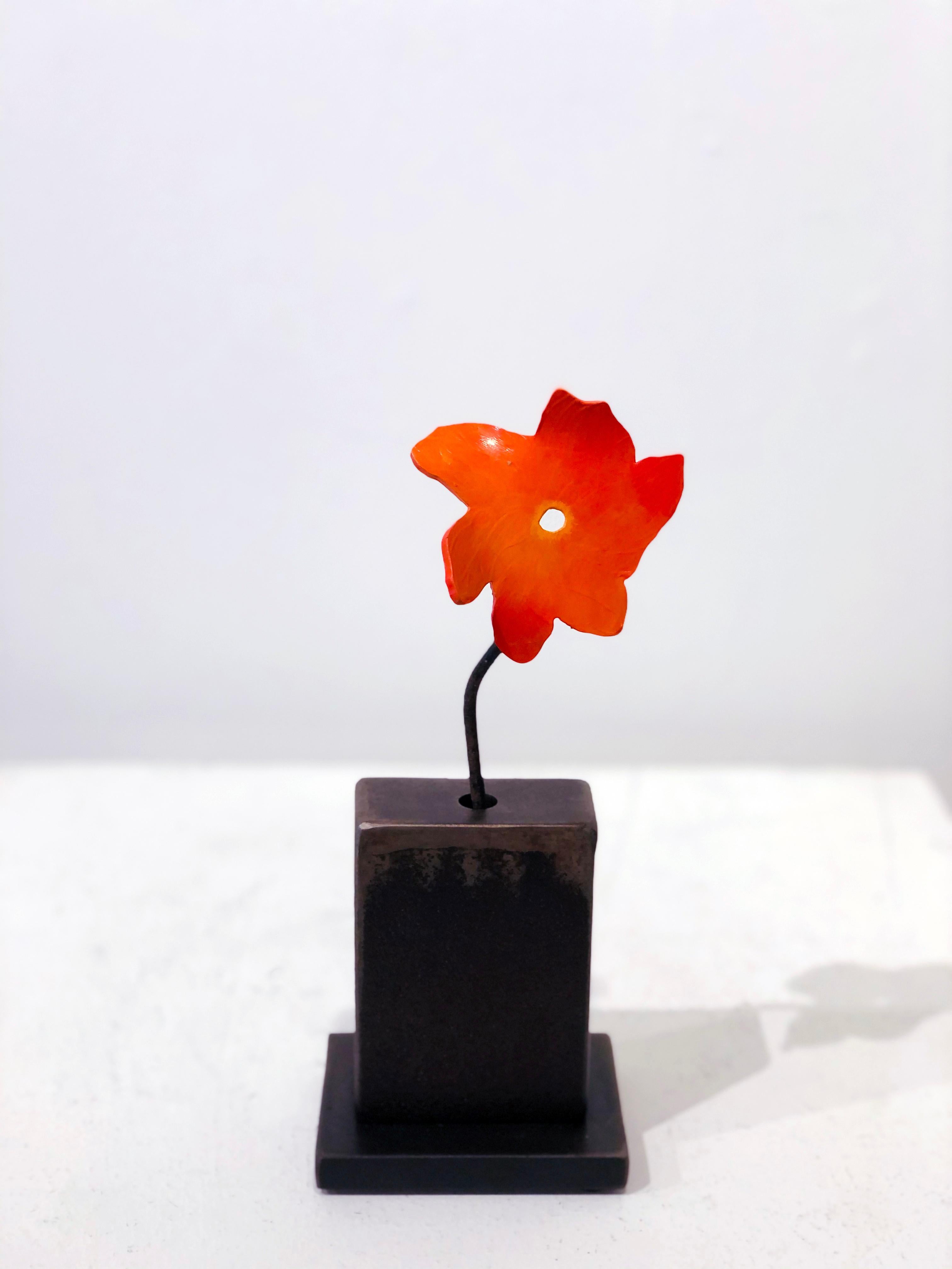 'Summer' by David Kimball Anderson, 2020. Bronze, steel, and paint, 10 x 4 x 4 in.  This sculpture features a square vase cast in bronze and finished in varying patinas of light and dark gray. The flower is painted in orange with a steel