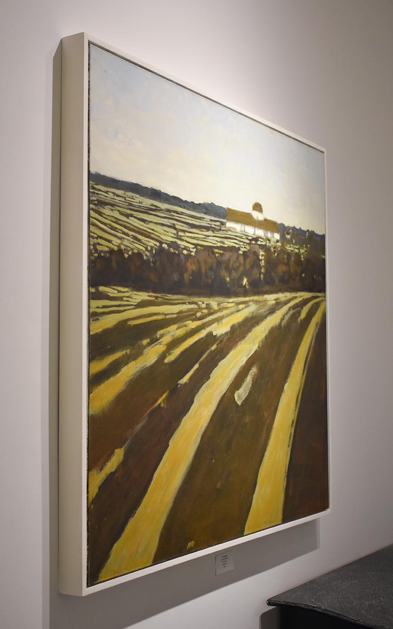 Abstracted landscape painting on canvas of a country farm with brown and yellow striped fields and a barn in the distance 
Fields and Distant Barn, Painted in 2013
Oil on canvas
43 x 46 inches, 45.5 x 47.5 inches in white painted custom wood
