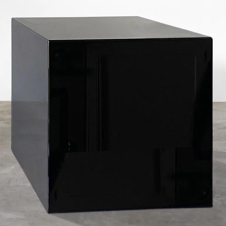 A rare cube shaped side table in mirror polished black perspex with David Lange label.
David Lange was an early exponent of perspex furniture designing very successful collections for Roche Bobois and other prominent modern furniture brands.
This