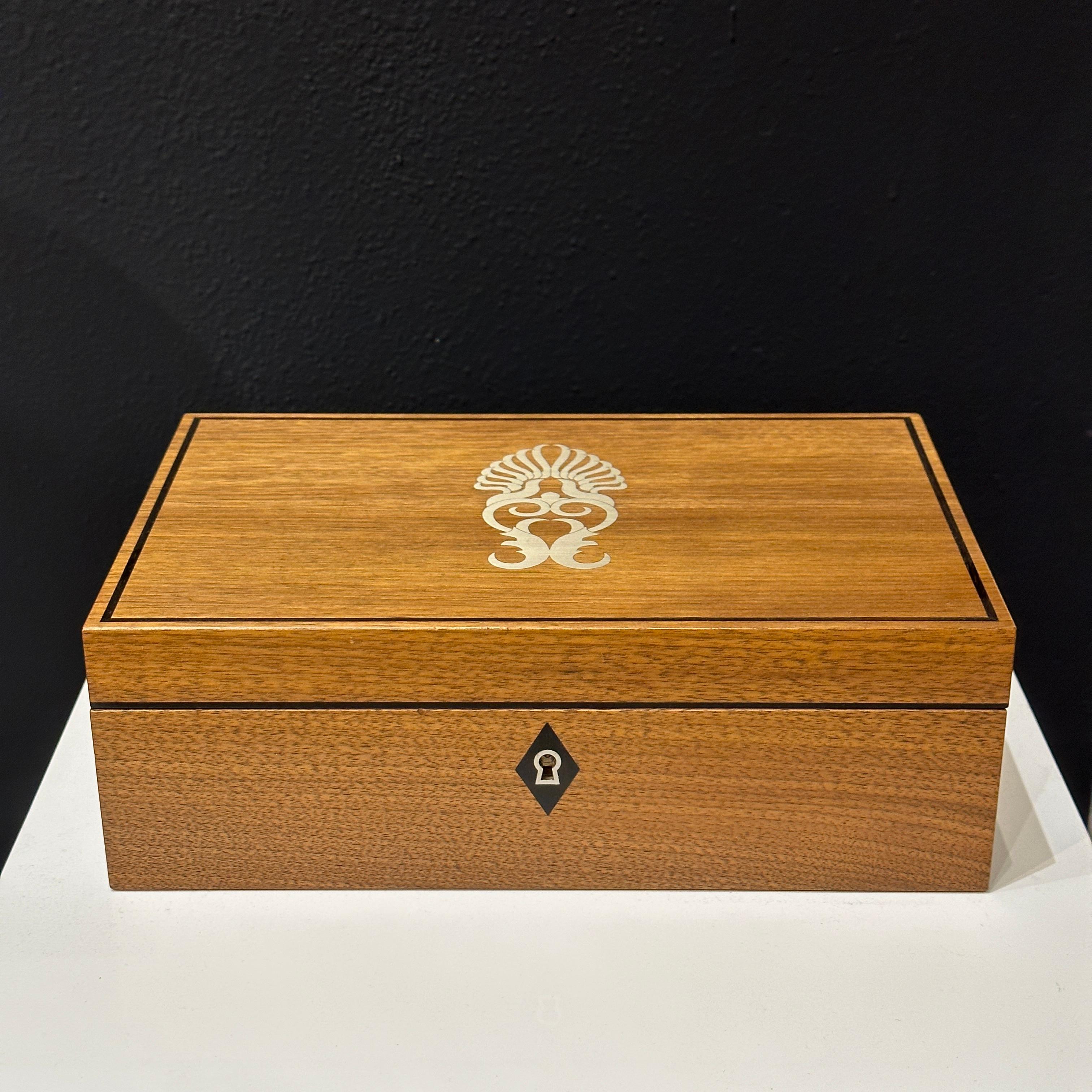 This is a gorgeous wood marquetry watch and cufflink jewelry box with silver inlay made by London producer of fine luxury goods, Linley. This fine box would make an excellent gift for yourself or a special person in your life. The incised LINLEY