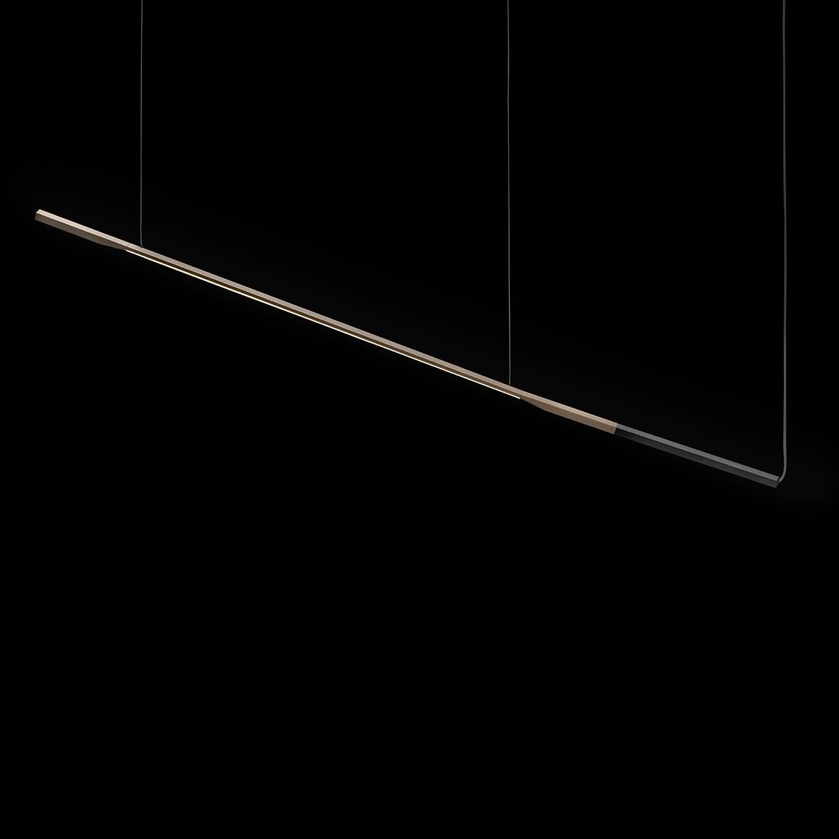 Suspension lamp 'Ilo' designed by David Lopez Quincoce in 2019.
Suspension led lamp giving direct light in metal. Aluminium rod structure anodized in satin bronze with anodized matt black terminal. Manufactured by Oluce, Italy.

The Ilo range,