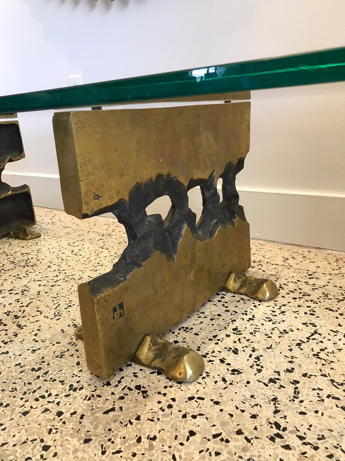 This very brutal small coffee table by David Marshall is comprised of two bronze bases and a thick (3/4 inch) glass top. Extraordinary design and all original and vintage.