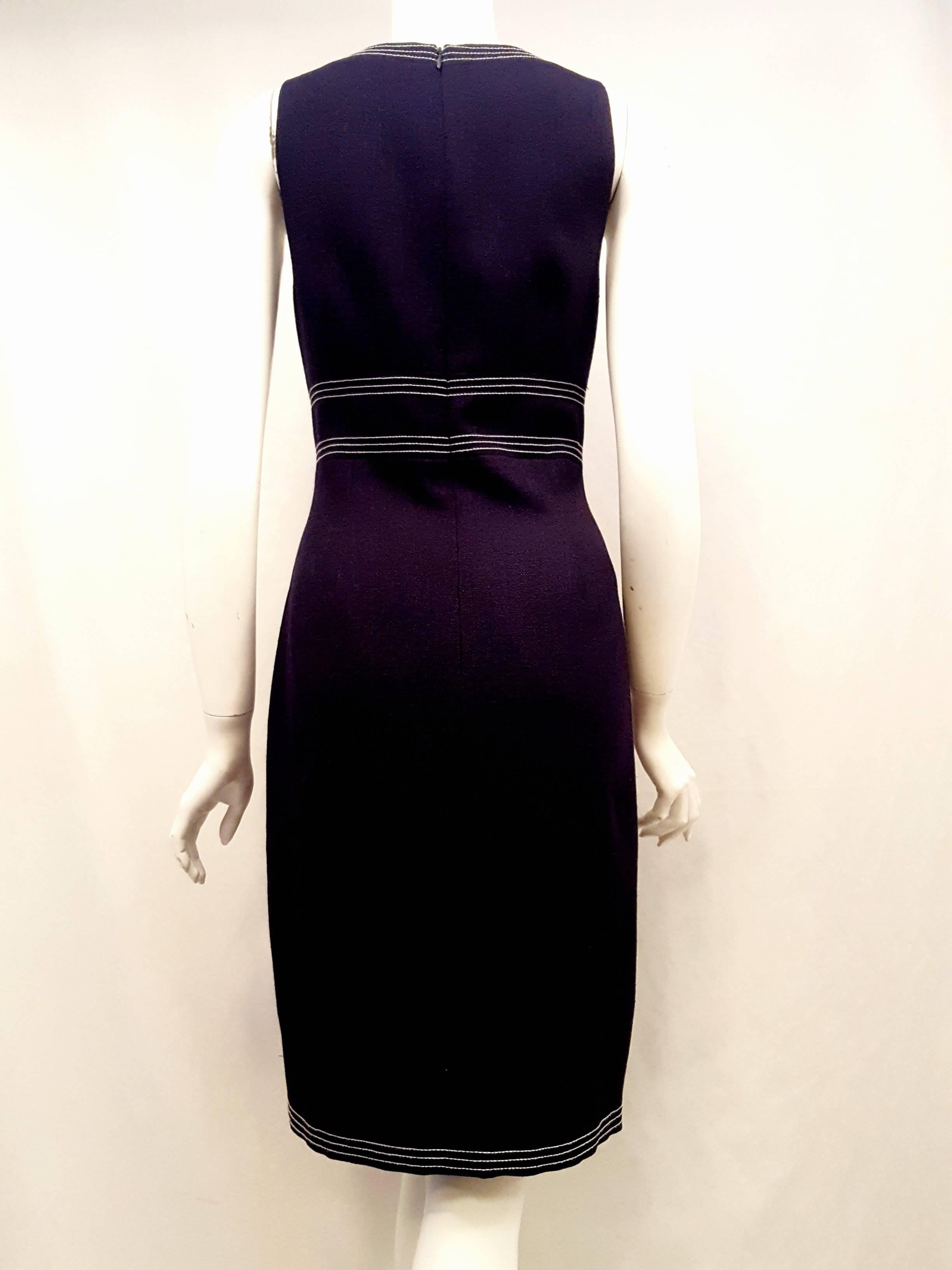 This David Meister sleeveless dress with white stitching around neckline, empire waist and hem is perfect for flawless professional attire at the office and then adding a cashmere sweater or bolero jacket for that special date. Also, a decorative
