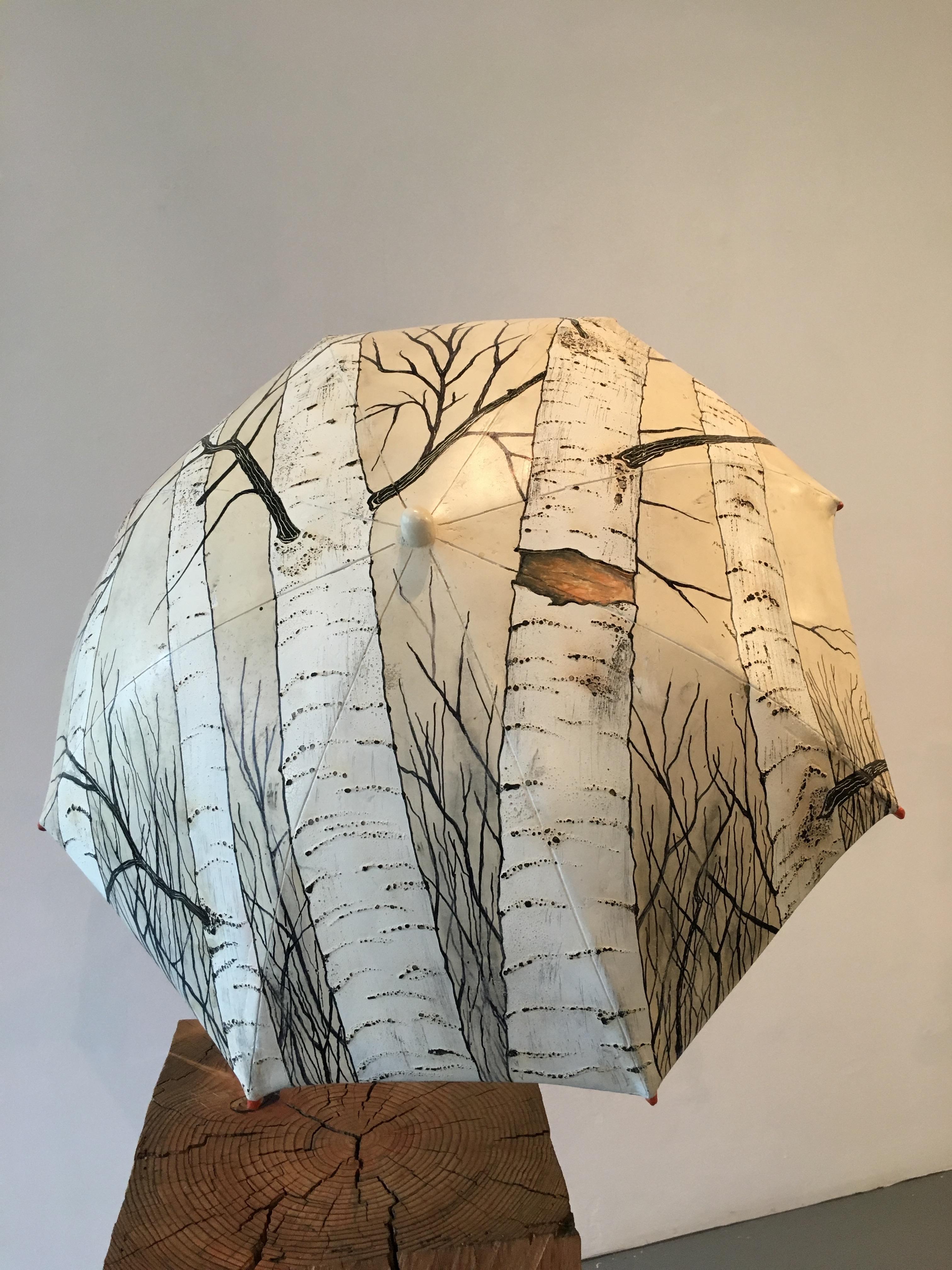 CANOPY - The trees on the  umbrella is a celebration of the beauty of the forest. The handle is a birch branch still alive. The big discarded timber is forever joined in death with the living branch. The log is gripping the umbrella to save the