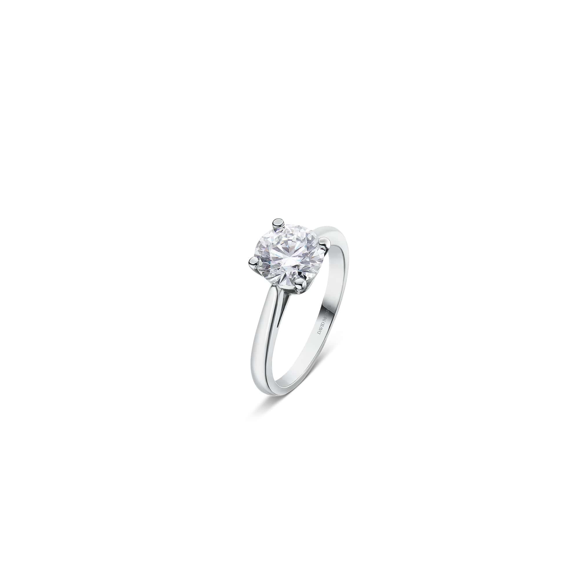Exclusively crafted by David Morris London, this 1.54 carat round white diamond platinum solitaire ring epitomizes sophistication and artistry. The meticulously designed four-claw setting elevates the diamond to new heights of brilliance, allowing