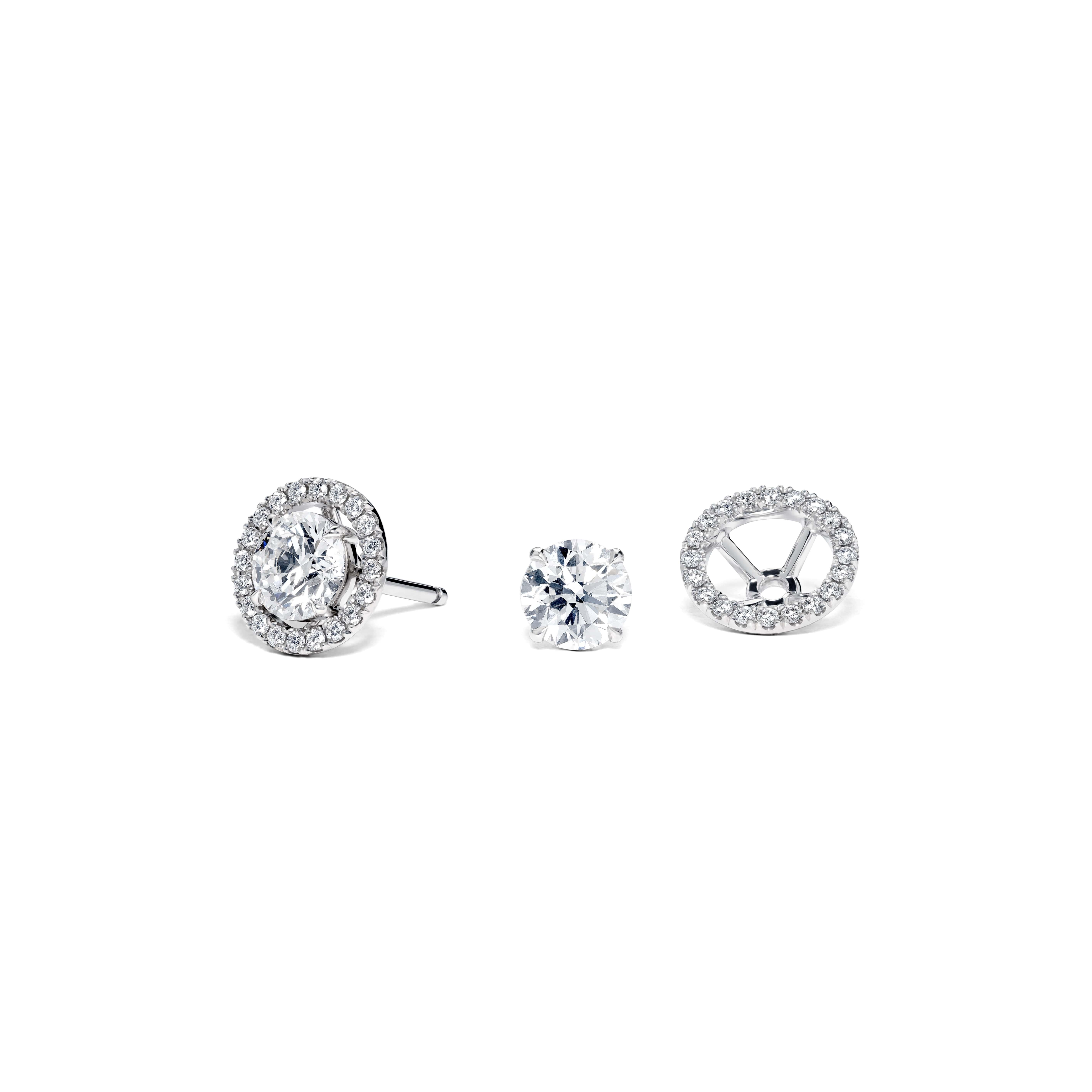 Crafted with meticulous attention to detail, these earrings feature a dazzling round brilliant diamond at the centre, with a detachable surround design. The central diamond is surrounded by a delicate halo of smaller diamonds, adding an extra layer