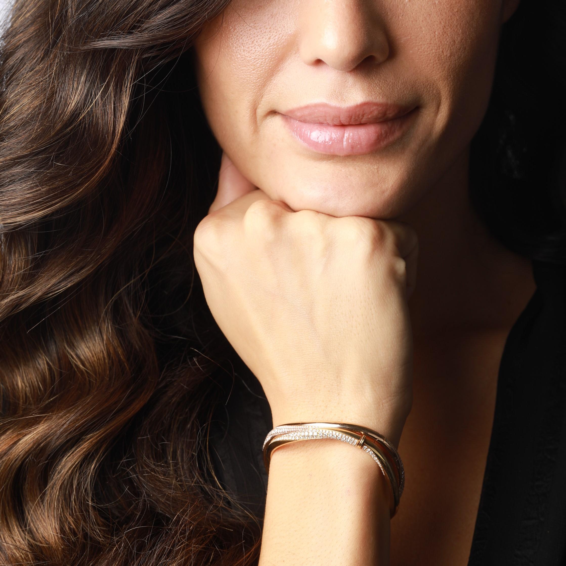 London jeweller David Morris is known for its classics with a twist, and this gold and white diamond bangle gives a timeless jewellery staple exactly that. This rose gold bangle has an unusual, slightly twisted composition that creates a wave-like