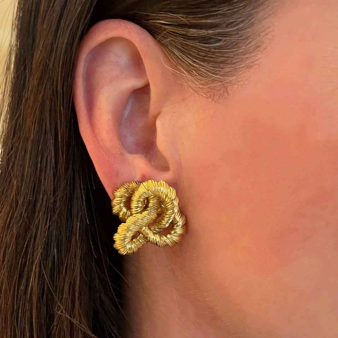 A pair of 18 karat yellow gold earrings by David Morris, London, UK, circa 1970. Stamped 18, 750, DM.

These sophisticated, highly textured, rope twist, clip-on yellow earrings are emblematic of the times in which they were made by a now iconic