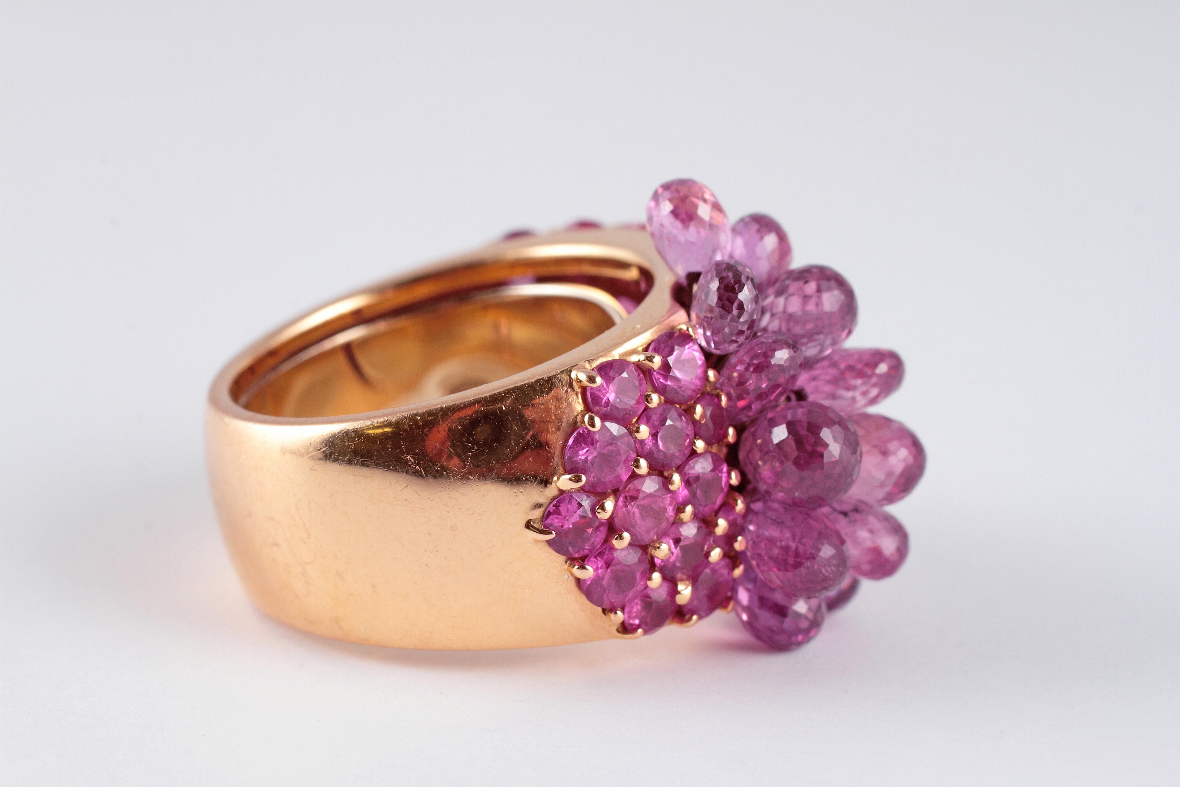 Such a fabulous burst of color from famed London designer David Morris.! The 41 prong-set, round pink sapphires and 15 en tremblant briolette-cut pink sapphires simply shine! Size 6 1/2, this ring has a sizer that could be removed to make it larger.