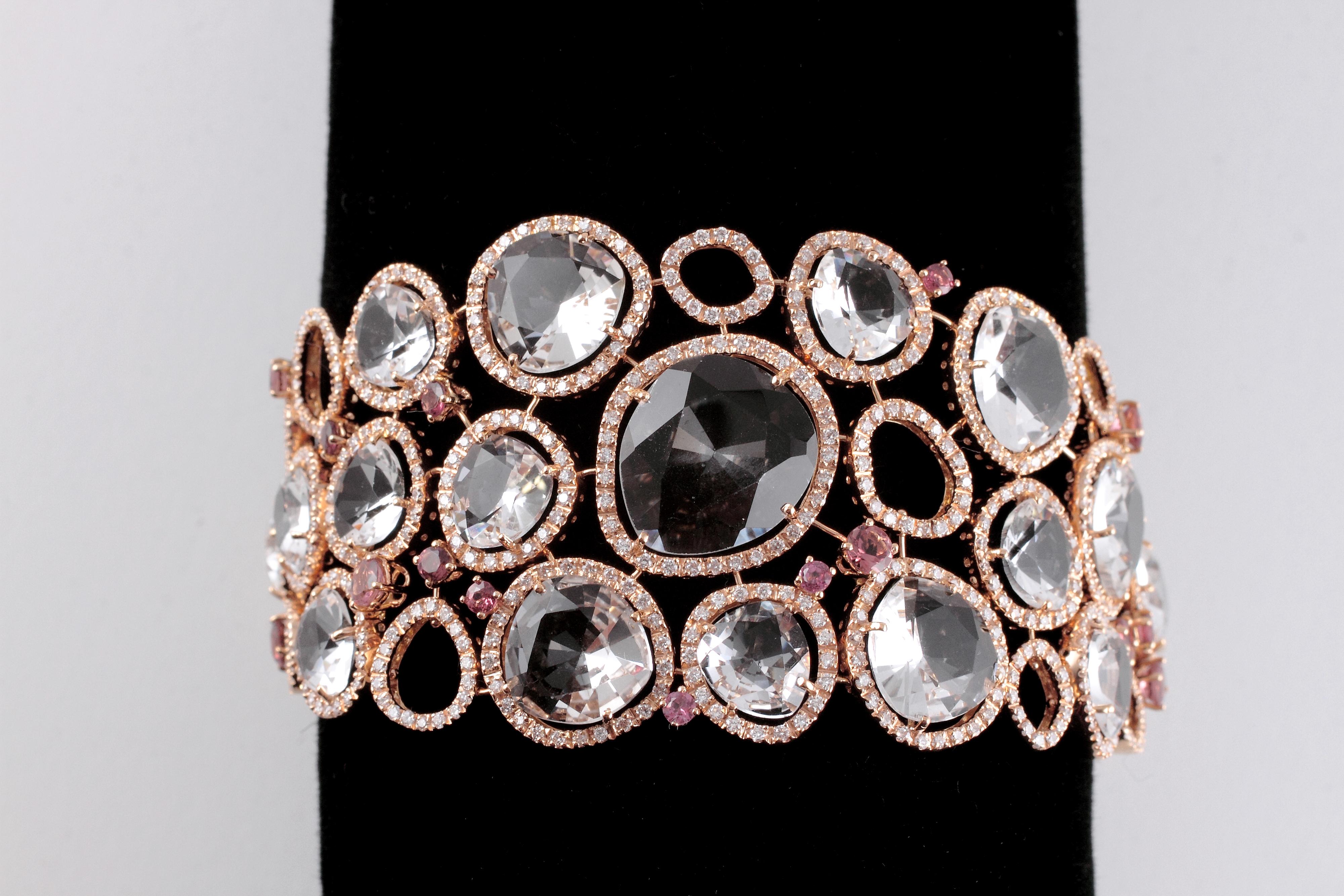 From famed London designer, David Morris, this stunning bracelet is in 18 karat rose gold and supports 5.53 carats of diamonds as trim, 53.50 carats of multi-shaped quartz and 2.50 carats of popping pink tourmaline stones! You can wear it tight on