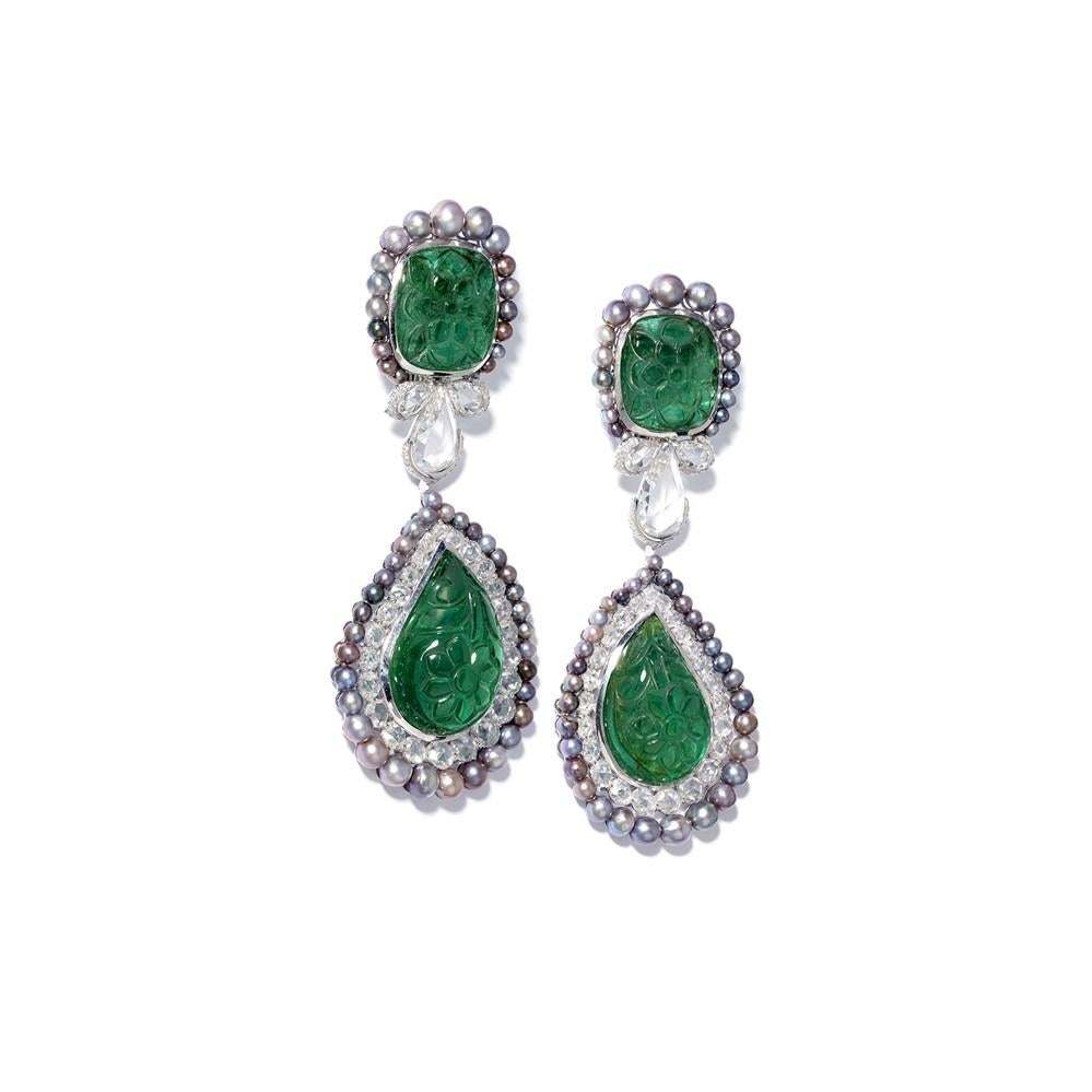 Carved emeralds, black pearls and diamonds make for a thrilling combination in these exquisite, one-of-a-kind emerald earrings from London jeweller David Morris.
The vibrant Zambian emeralds are each carved with a floral pattern, with the 