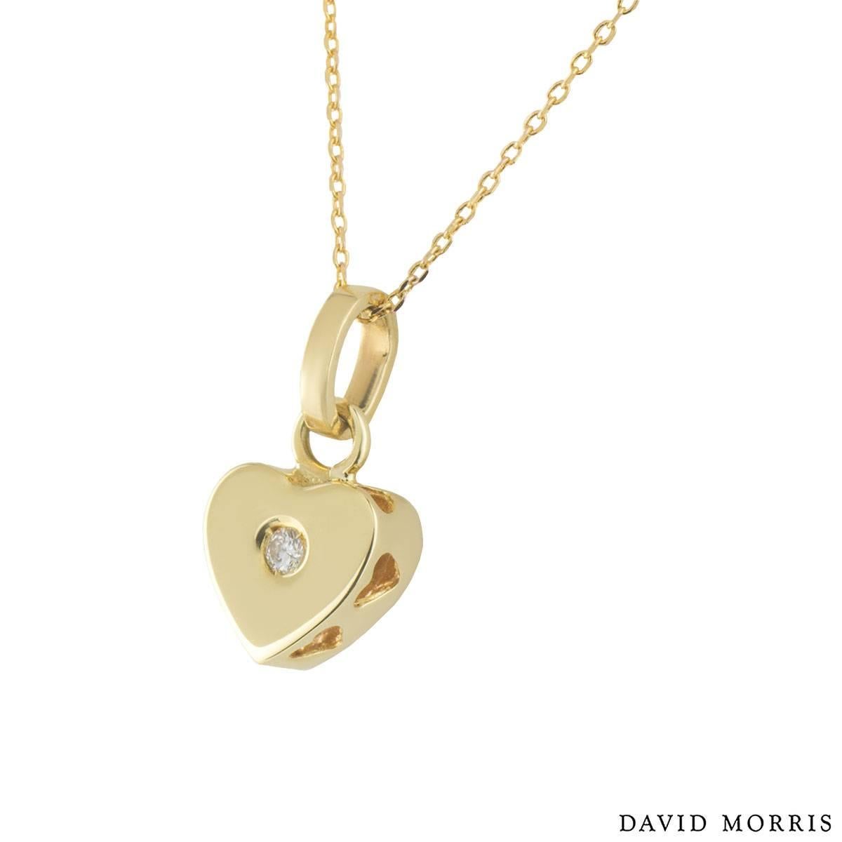 A beautiful 18k yellow gold diamond David Morris pendant. The pendant comprises of a heart motif with a round brilliant diamond in a rubover setting. Complementing the pendant is another round brilliant cut diamond on the other side in a white gold