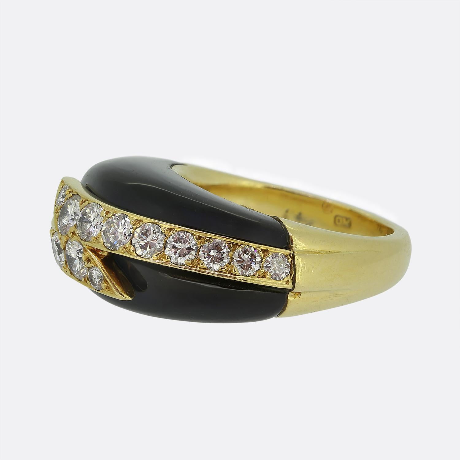 Here we have a striking ring crafted by the British luxury jewellery designer, David Morris. The design features a bold black onyx backdrop, elegantly contrasted by two rows of bright white round brilliant cut diamonds. The diamonds are set in a