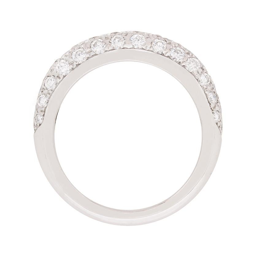 Featuring from the David Morris collection, this half eternity ring is pave set with dazzling diamonds. Combined, the weight adds up to 0.90 carat and the diamonds are F in colour and VS in clarity. The setting work is done to an impeccable standard