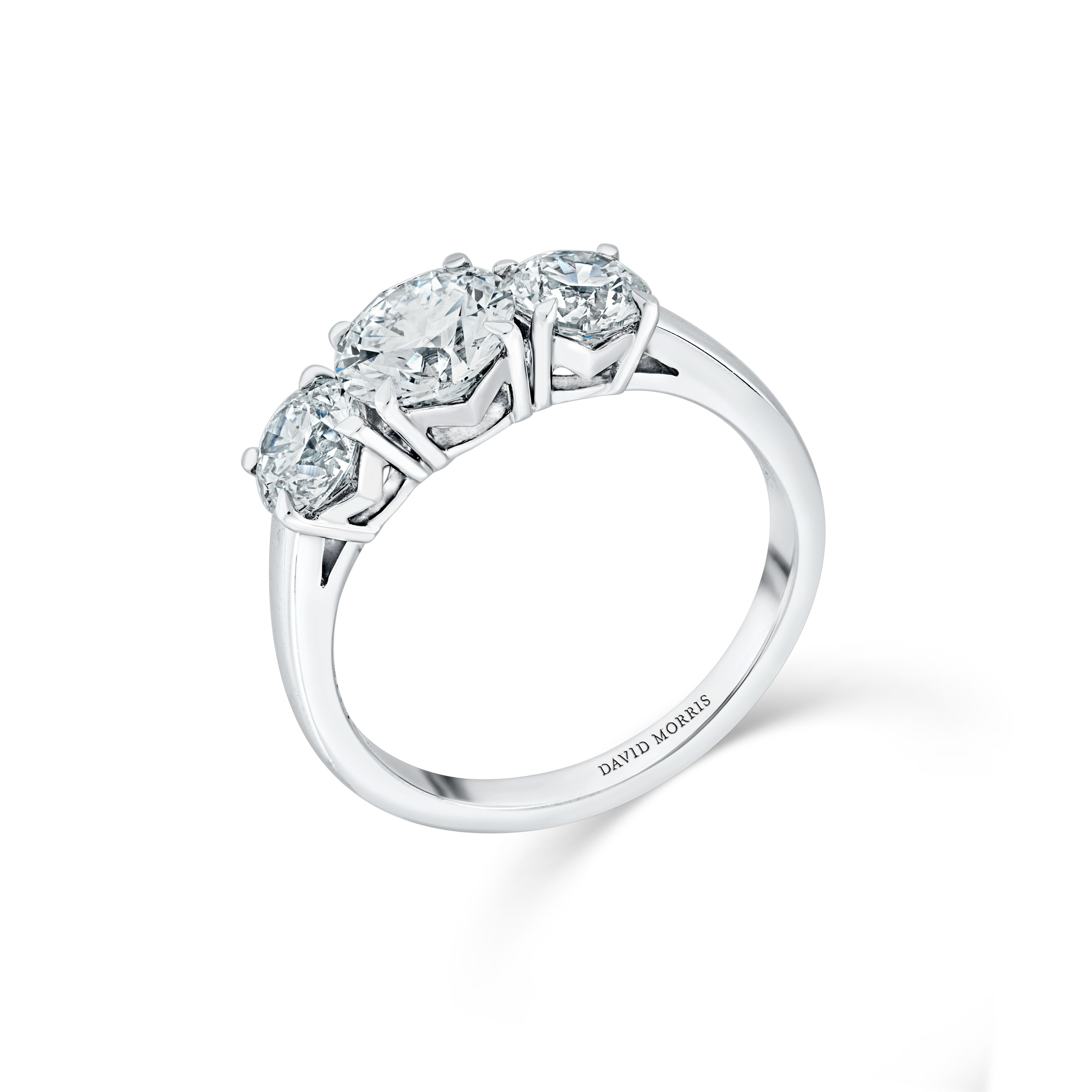 This ring is utterly stunning, at the heart of this enchanting creation, a mesmerizing 1.01 carat round brilliant-cut diamond flanked by two exquisite round brilliant-cut diamonds each weighing 0.50 carats. All three diamonds are graded colour F