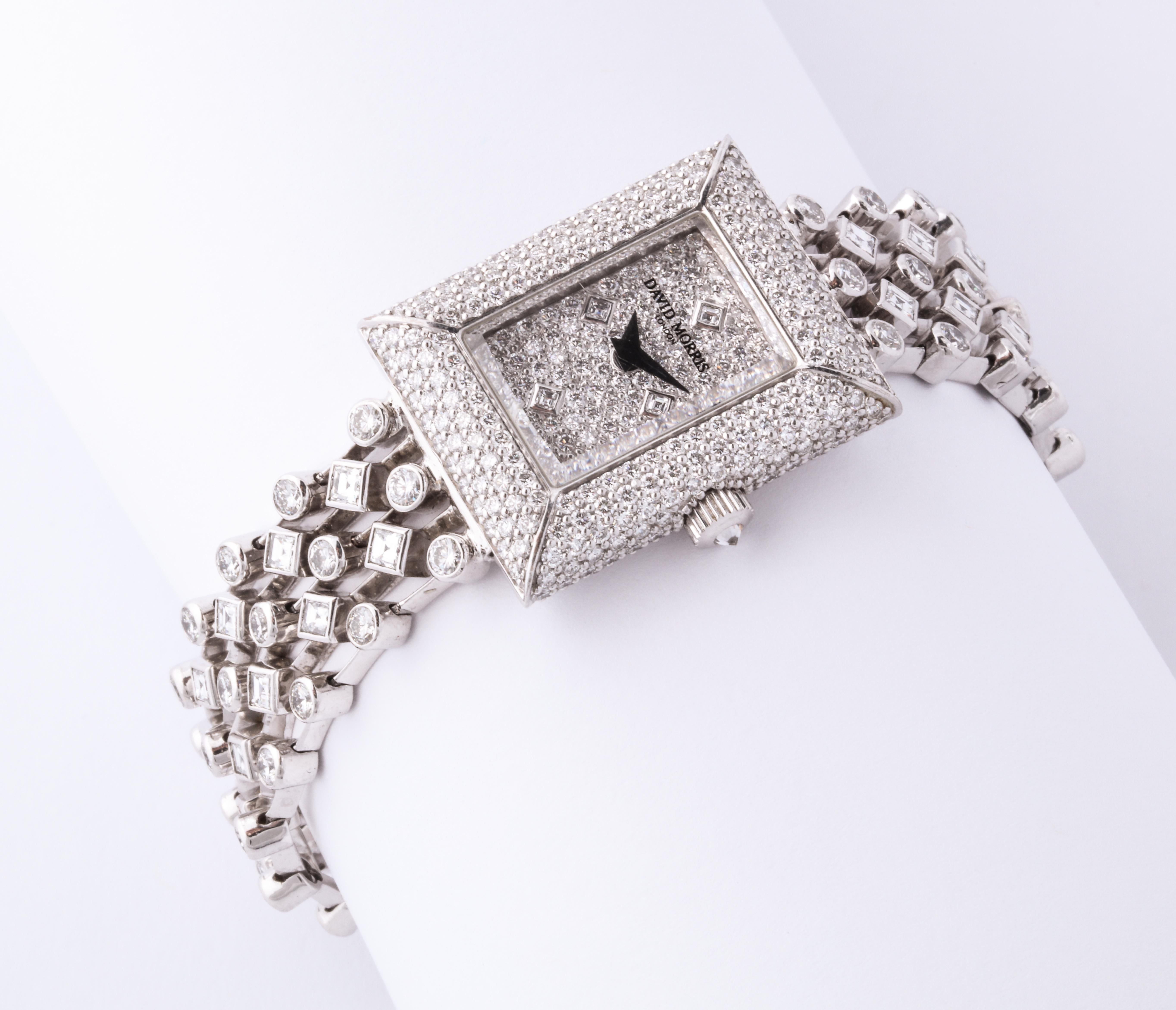 Blindingly white diamonds are exquisitely set in this platinum and diamond dress watch by the infamous London jeweler David Morris.  Four supple lines of square and round cut stones make up the bracelet which magically supports the rectangular watch