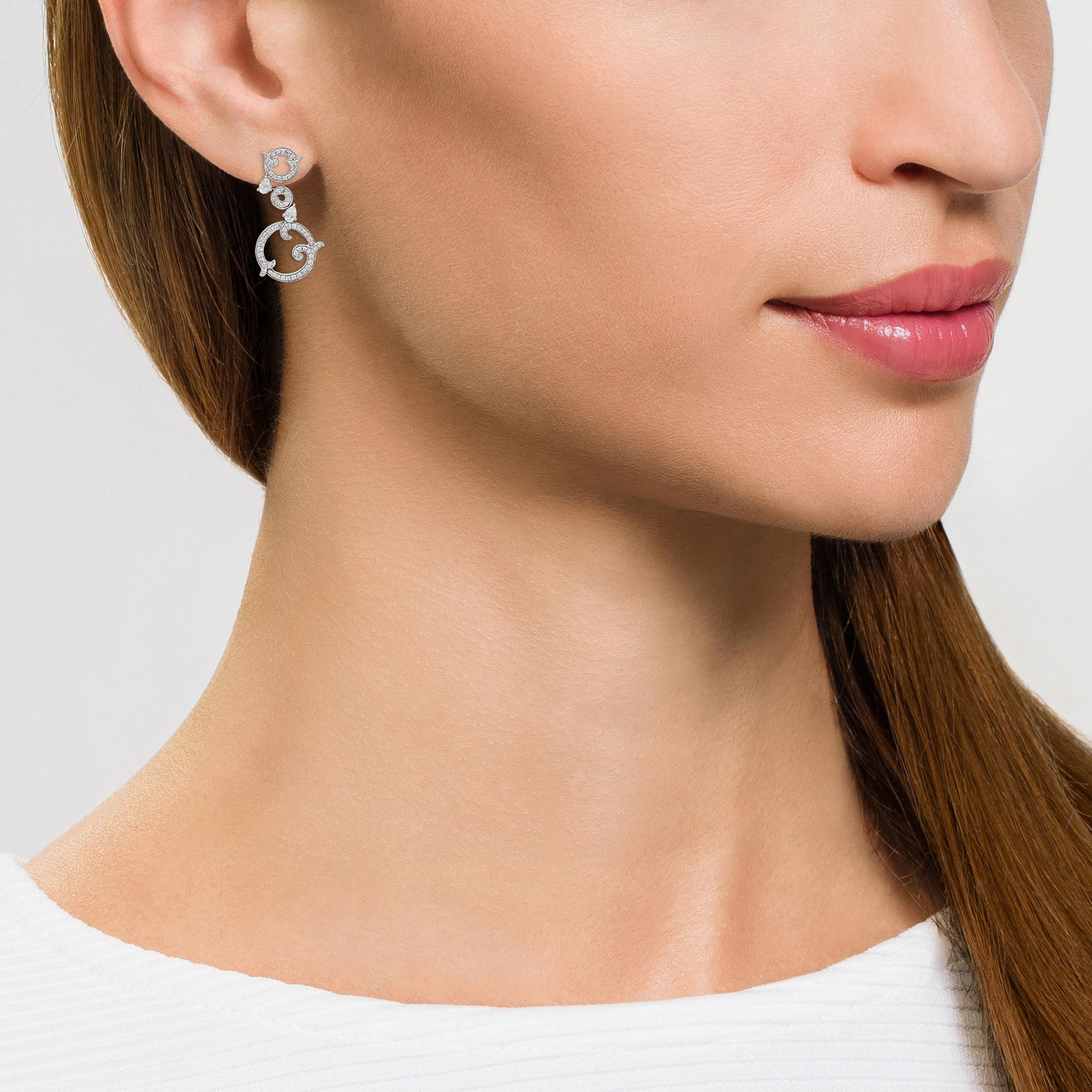 For a contemporary and individual take on white diamond earrings, look to this unique, statement-making swirl design from David Morris. These eye-catching earrings are composed of three diamond-embellished circles with overlapping, vine-like