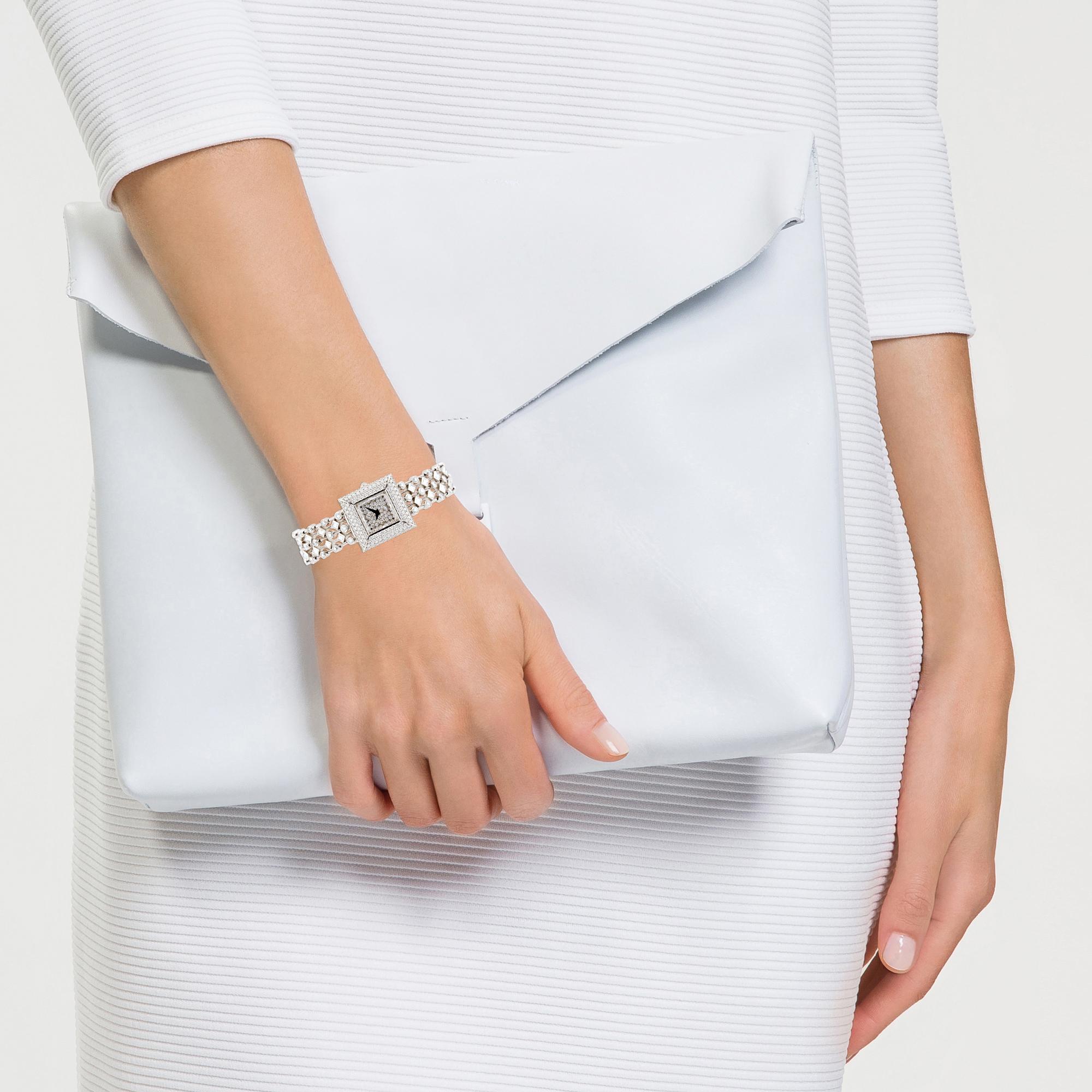 Fans of David Morris’s extraordinary jewellery will find this spectacular white diamond watch creation equally captivating. The watch’s bold, square bezel is set entirely with white diamonds, which extend to the underside of the bezel towards the