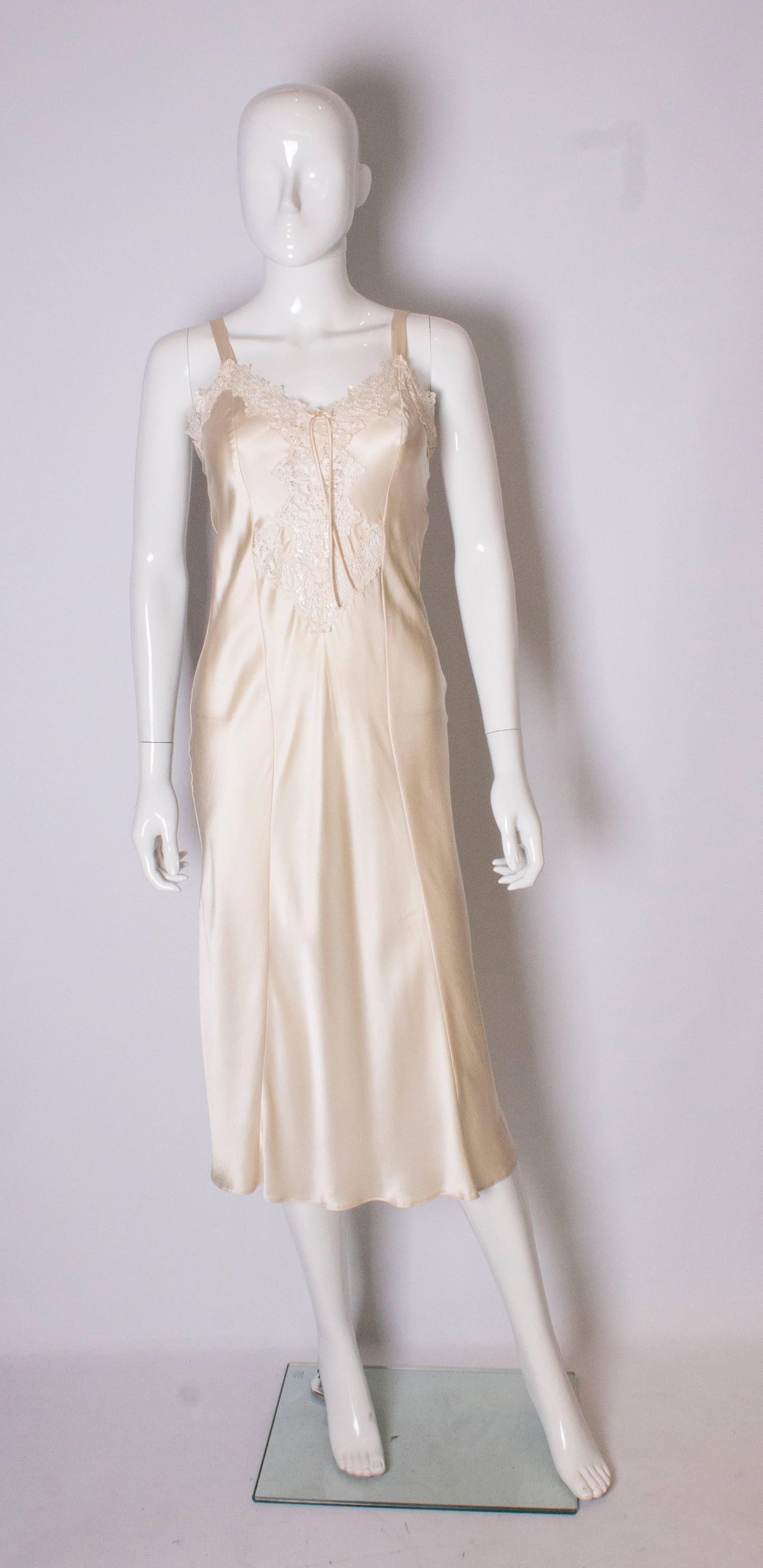 A charming silk night dress by David Nieper. In a heavy ivory silk , the nightdress has a pretty lace insert at the front.