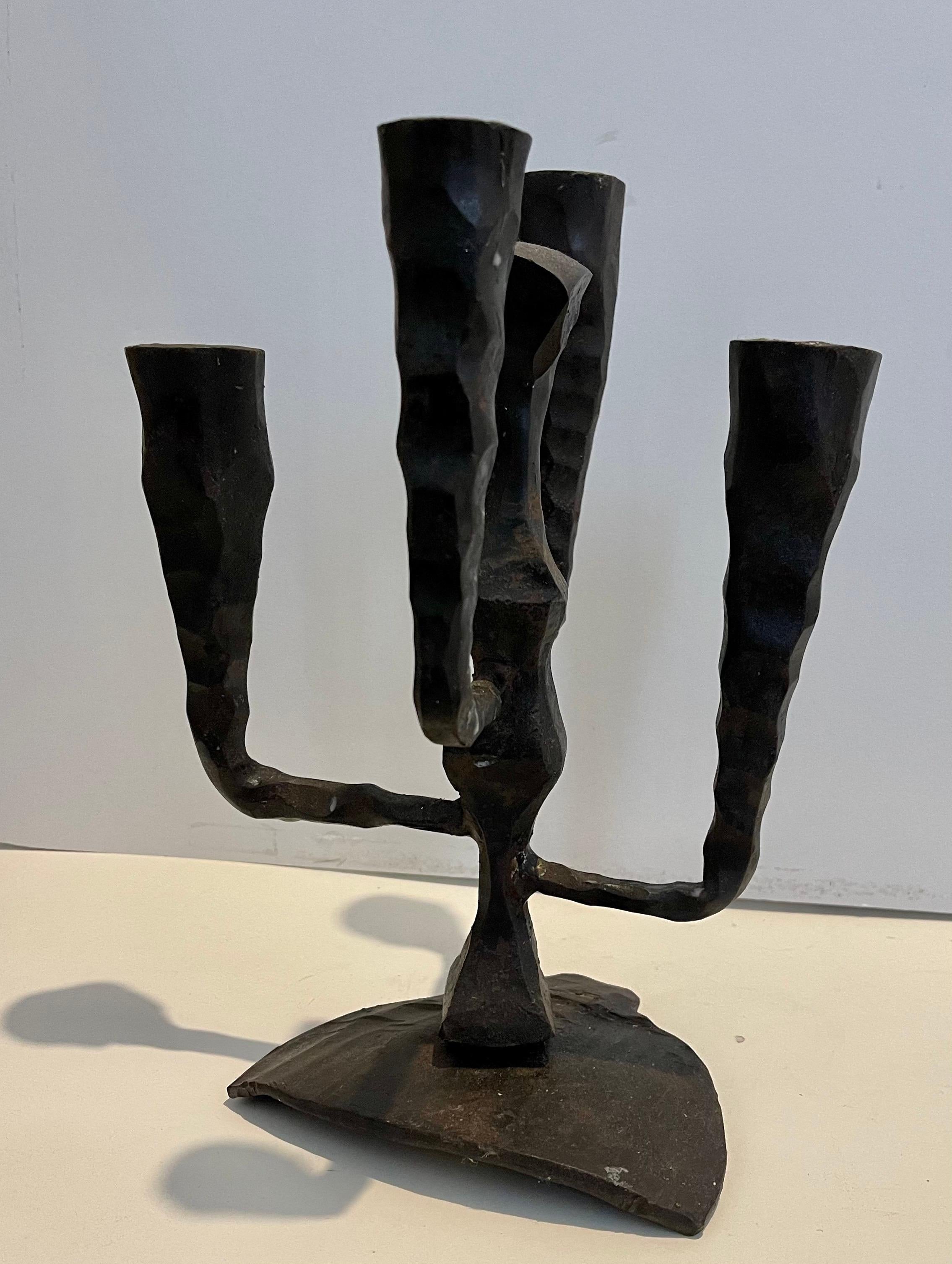 Hand forged Iron four light brutalist candelabra 
 Judaica Menorah Sculpture
measurements are approximate.

David Palombo was an Israeli sculptor and painter. He was born in Turkey to a traditional family and immigrated to the Land of Israel with
