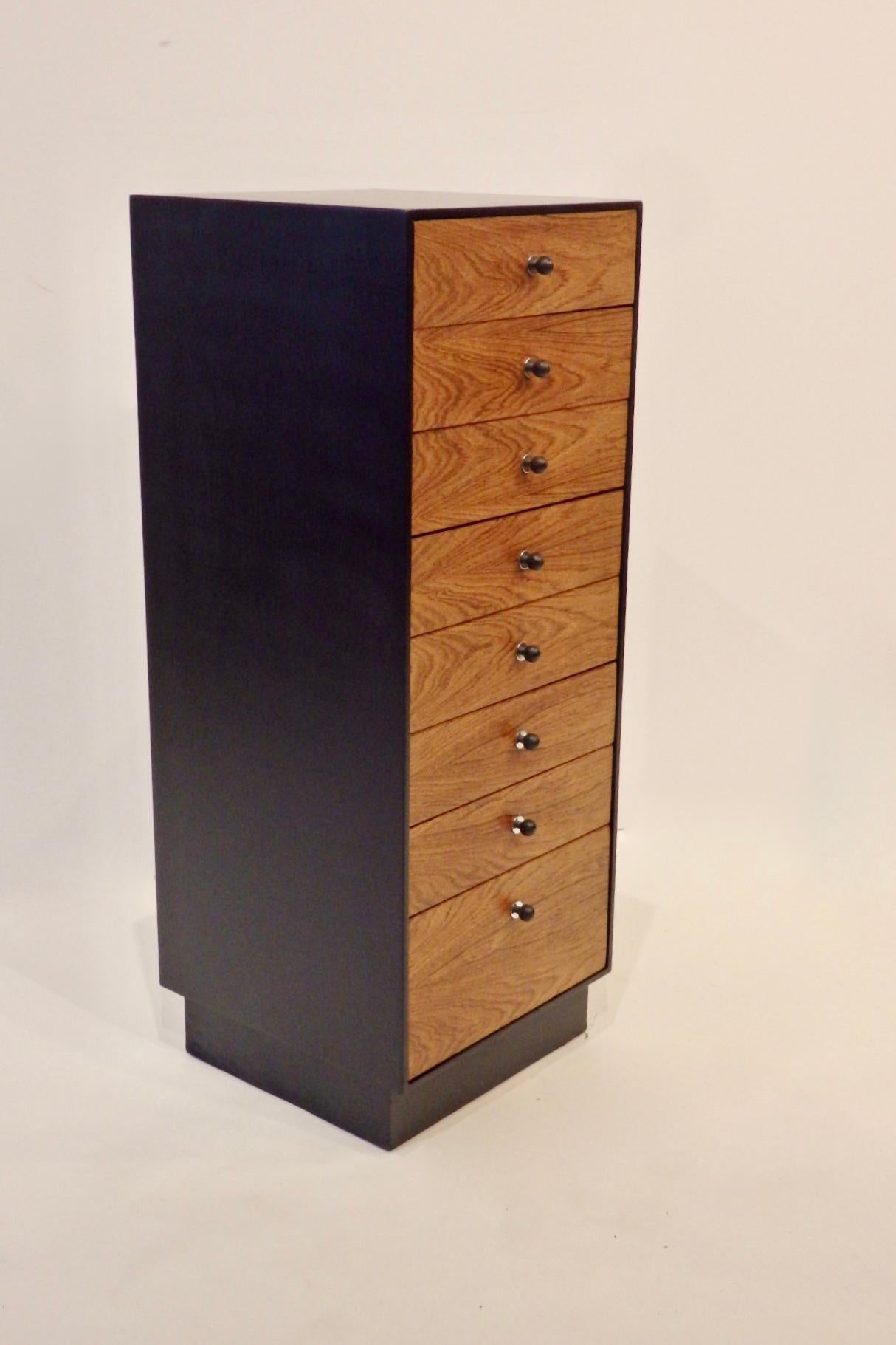 Black satin finished lingerie or linen cabinet with rosewood face drawers having cast iron ball pulls with chrome backplate. Designed by David Parmelee for Founders furniture.