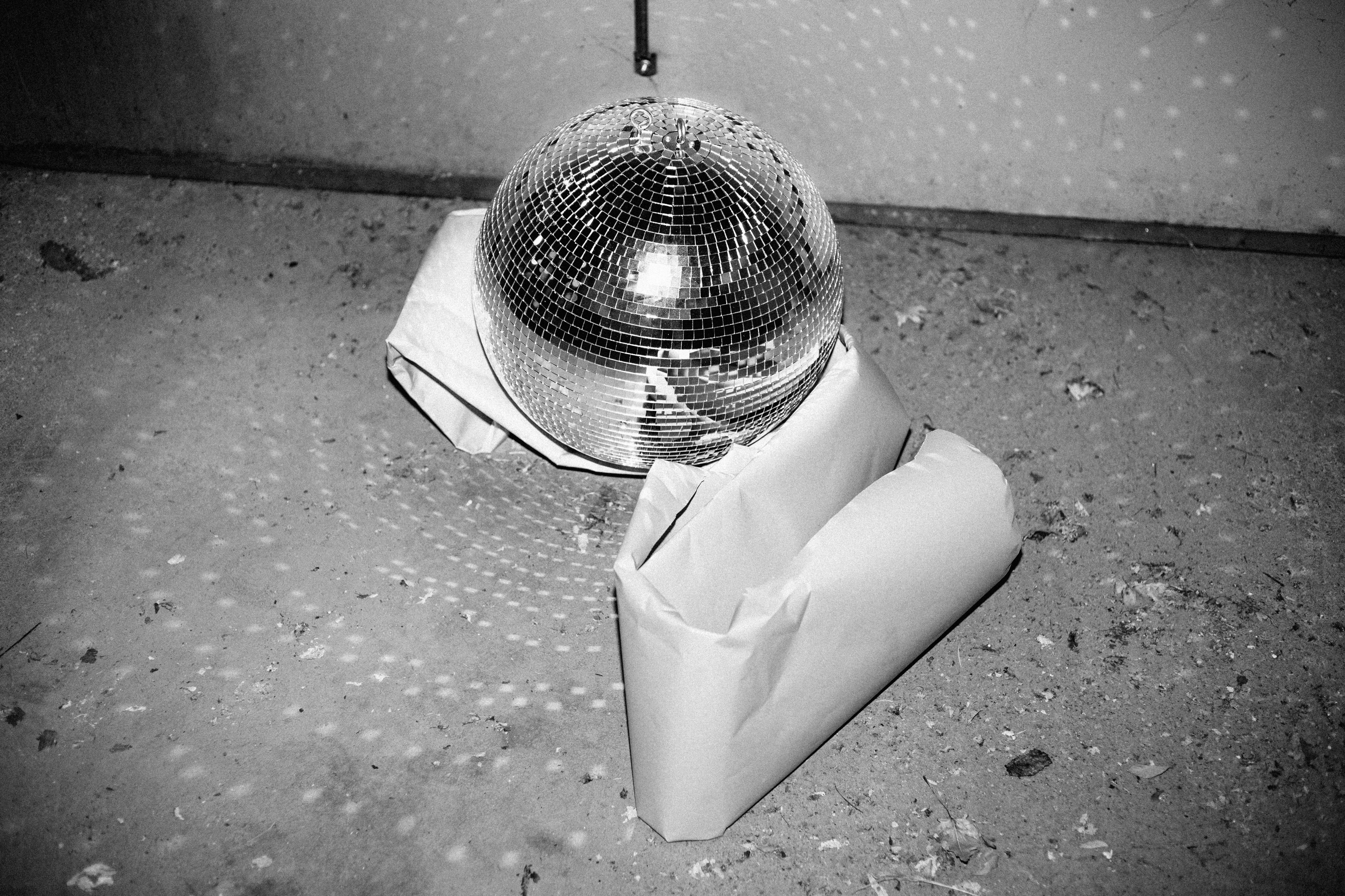 David Pugh Figurative Photograph - Disco Concr (Disco, Disco Ball, Black and White, Shiny, Concrete, Floor)