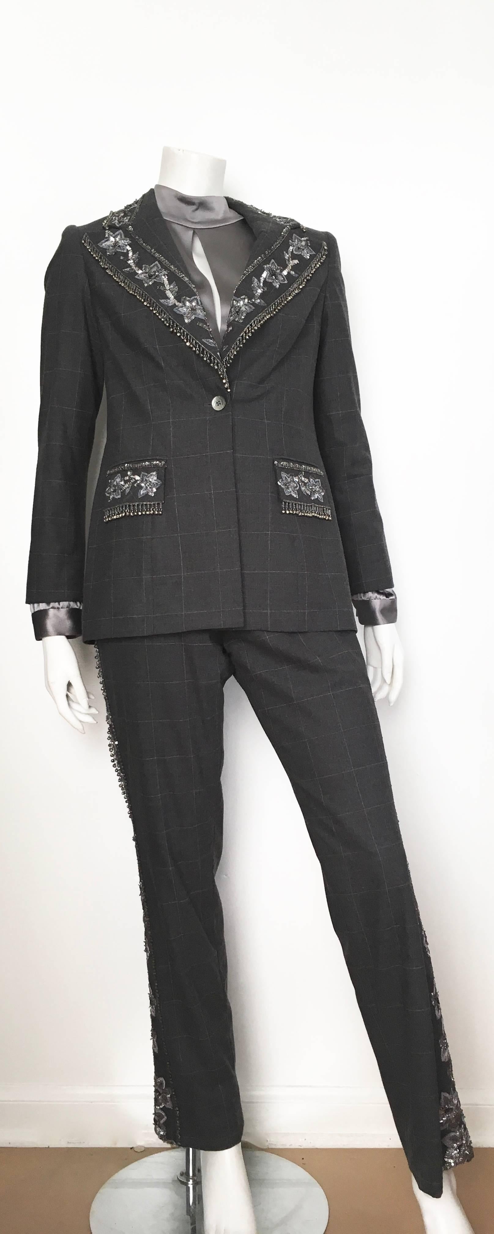 David Rodriguez three piece grey beaded pant suit with solid grey silk blouse is a size 8.   This impeccable whimsical pant suit trimmed in silver sequin & beads is just gorgeous. Head to toe this playful pant suit set will have all eyes on you when