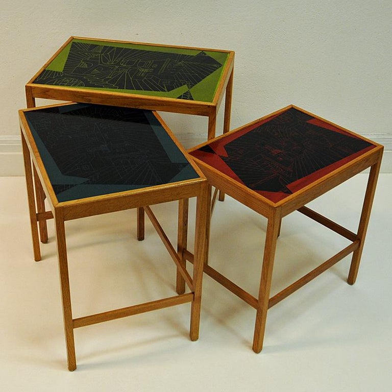 Vintage Nesting tables from the Futura-series item nr 571-005 designed by Swedish designer David Rosén, 1953. Made of enamel and oak.  Sizes: Table 1: 56,5cmH x 55cmWx 40cmD. Table 2: 52.5cmH x 50cmW x 36.5cmD. Table 3: 48.5 cmH x 45cmW x 30