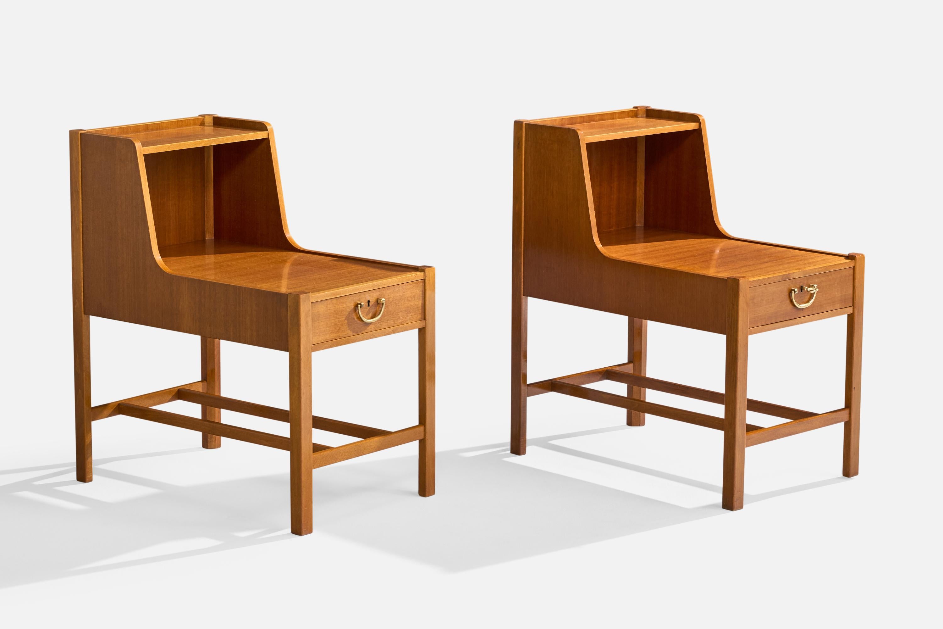A pair of wood and brass nightstands from the 